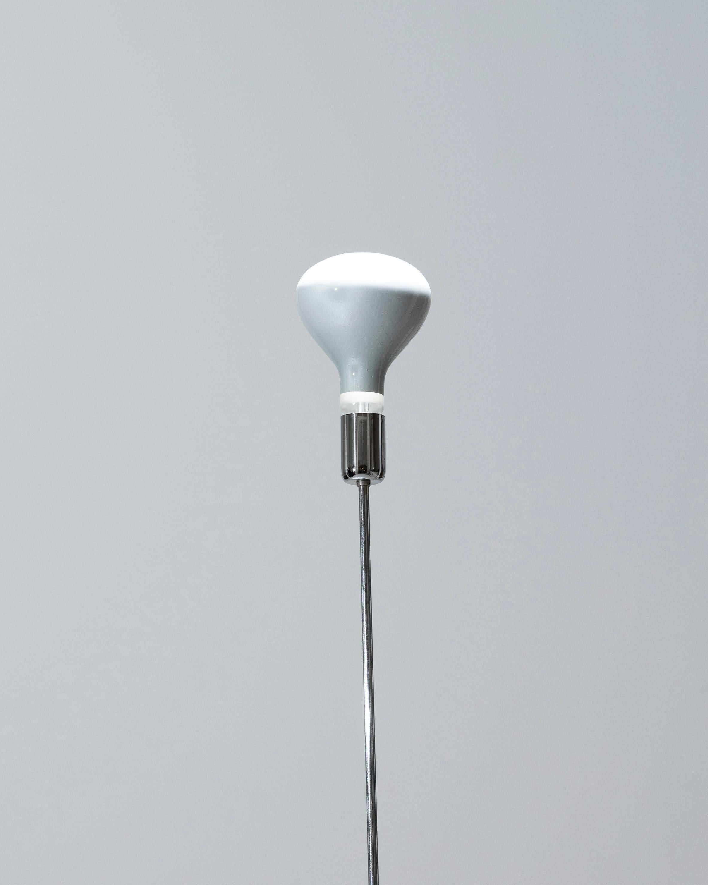Pair of “Notti” floor lamps by designers Tanzi Gigi & Pepe, distributed by Dalca, in an IOtalian minimalist style from the 1970s. The base is in metal, and the diffuser in glass. Good condition. functional, with European plug, the connection is