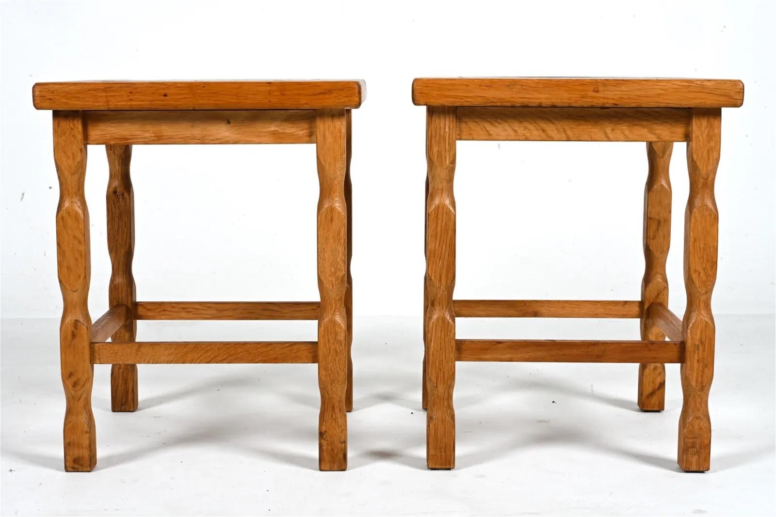 Pair of plant stands or end tables in solid oak, each inset with a beautiful ceramic tile. Wear due to age and use, visible water marks. 