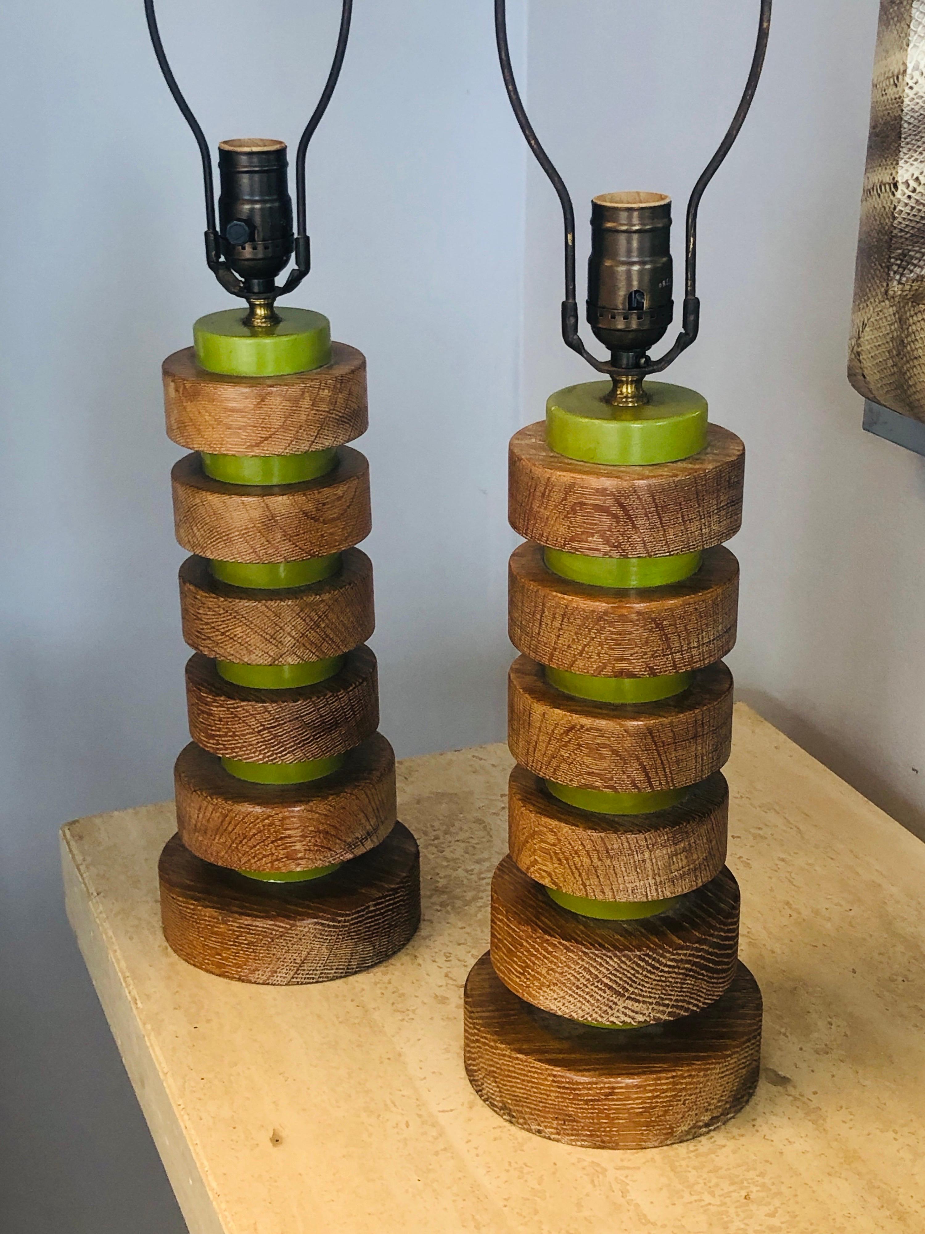 A pair of period lamps. Most probably a Paul Frankl design or in his style.
Thick concentric oak disks are interlocked with green ones.