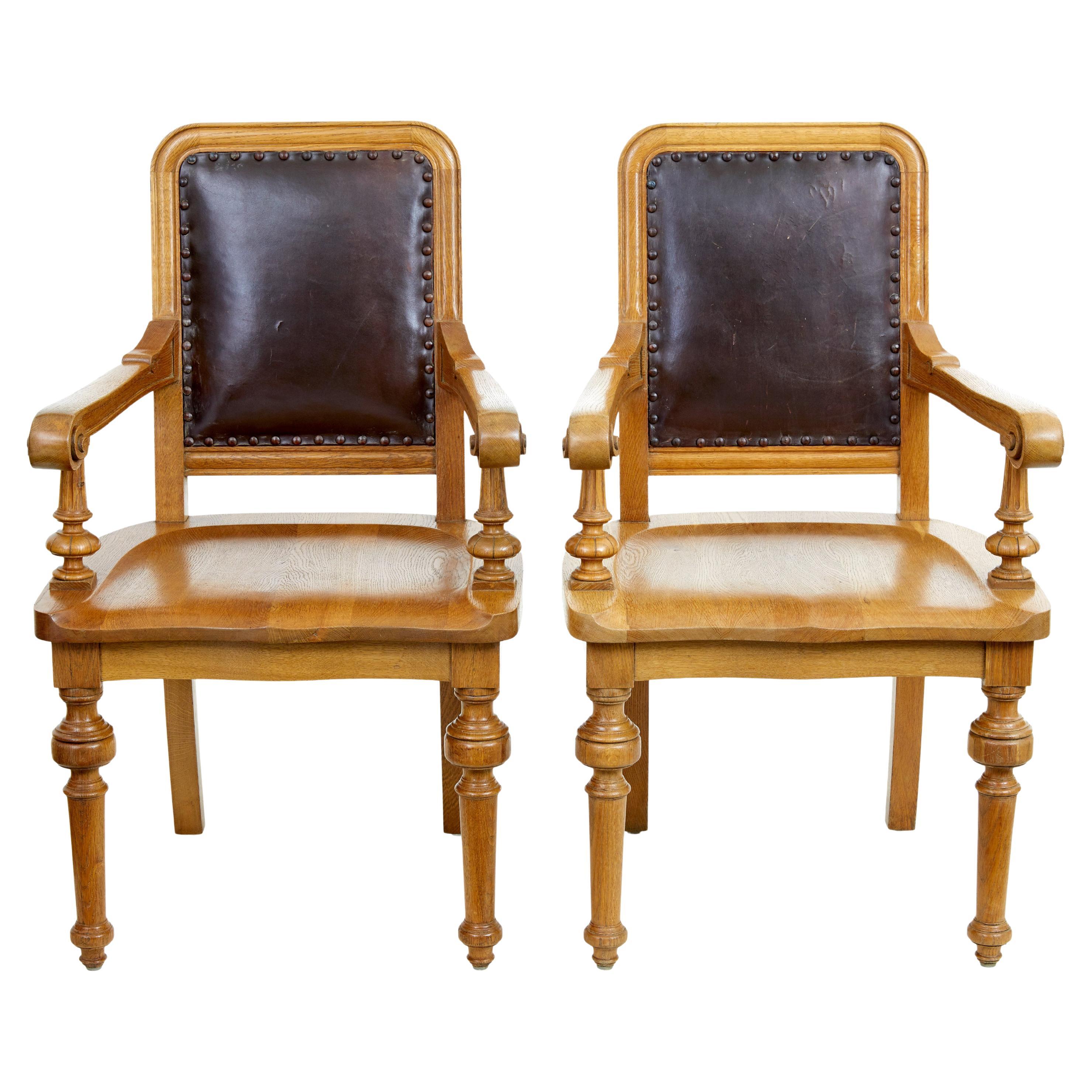 Pair of oak and leather arts and crafts library chairs
