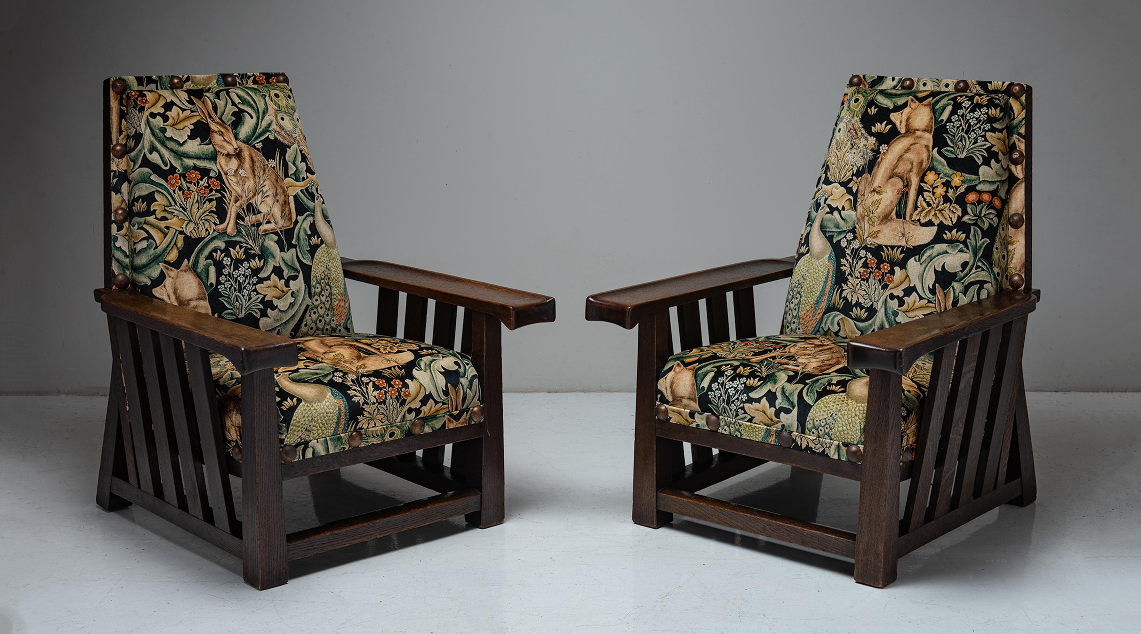 Pair of oak armchairs by Leonard Wyburd in cotton velvet from William Morris
England, circa 1900

Substantial Arts & Crafts armchairs with slatted oak sides and original brass studs, reupholstered in Forest Velvet by William Morris.
Measures: