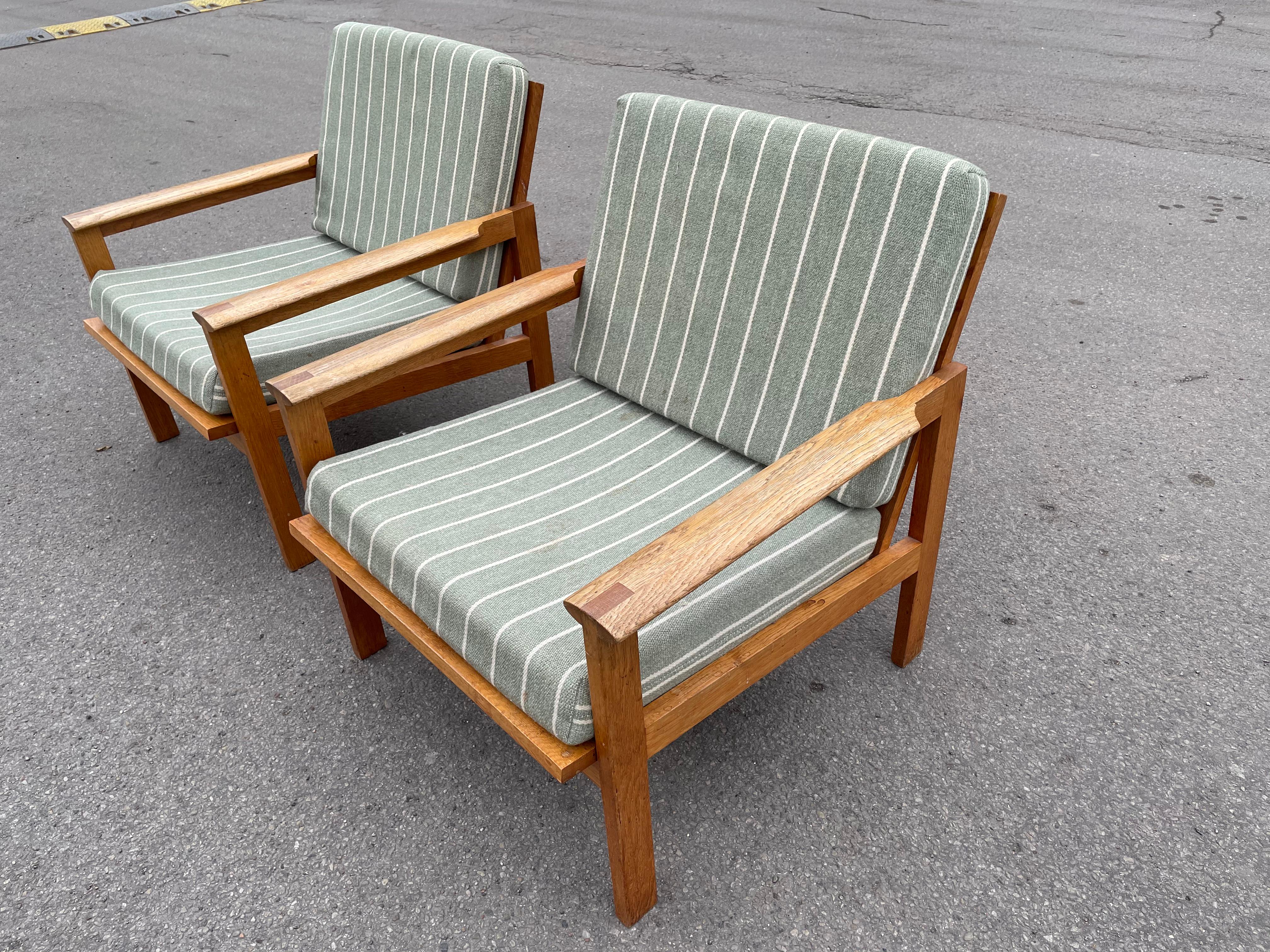 Pair of midcentury armchairs designed by Illum Wikkelsø, produced by Niels Eilersen in Denmark, designed in 1959, oak frames with loose cushions in original upholstery.