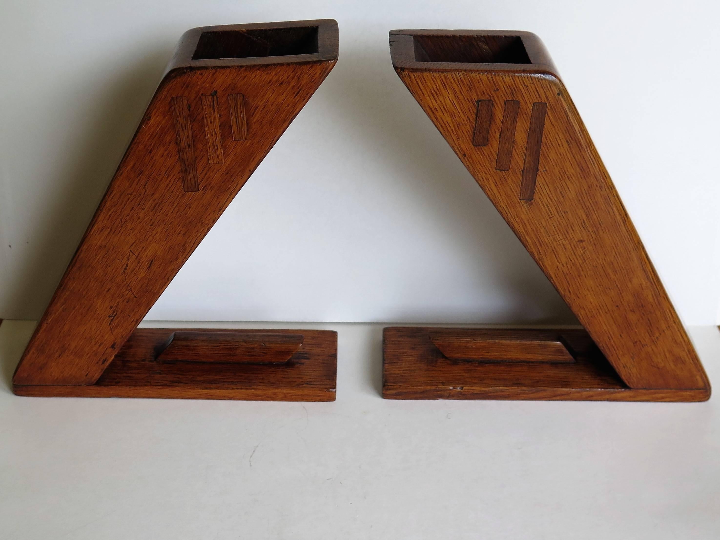 These are an unusual and distinctive pair of hand made oak vases or book ends made during the Arts & Crafts period of the late 19th century, circa 1890.

They have been carefully hand made with an emphasis on design, with an emphasis on the Arts and