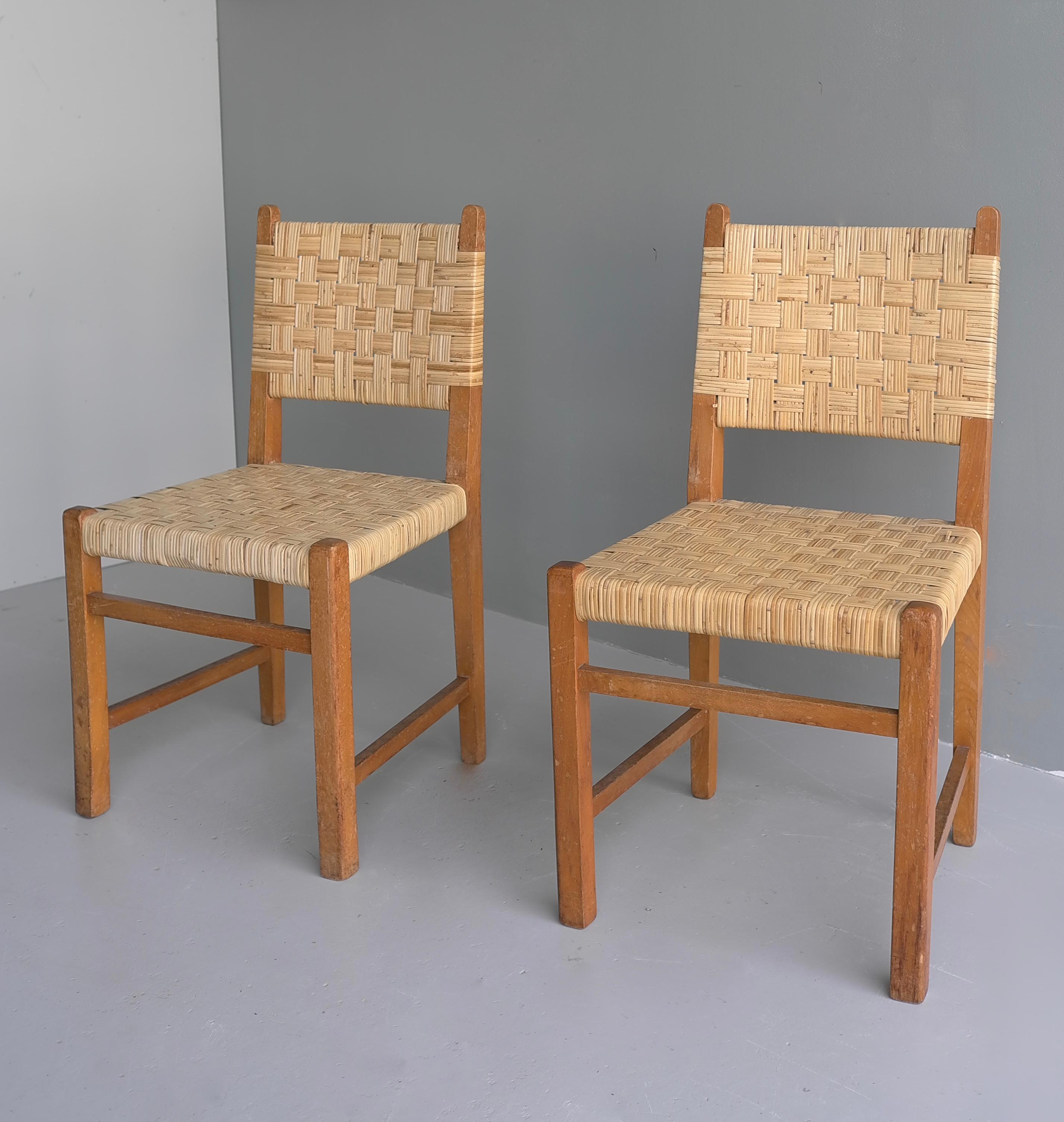 Pair of oak chairs with cane upholstery in style of Pierre Jeanneret.