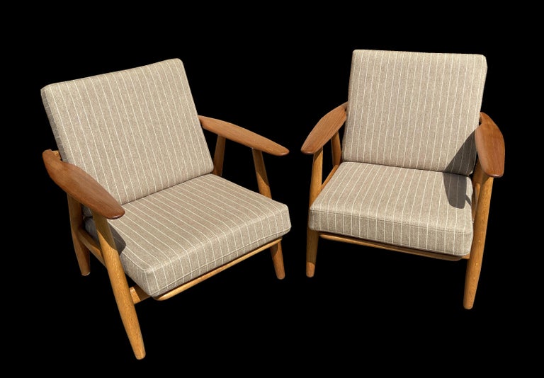 These are a particularly good original pair of Wegner Cigar chairs, all original apart from the covers on the cushions, which retain the original interiors, so feel as they should to sit in, with quality striped light brown fabric covers.