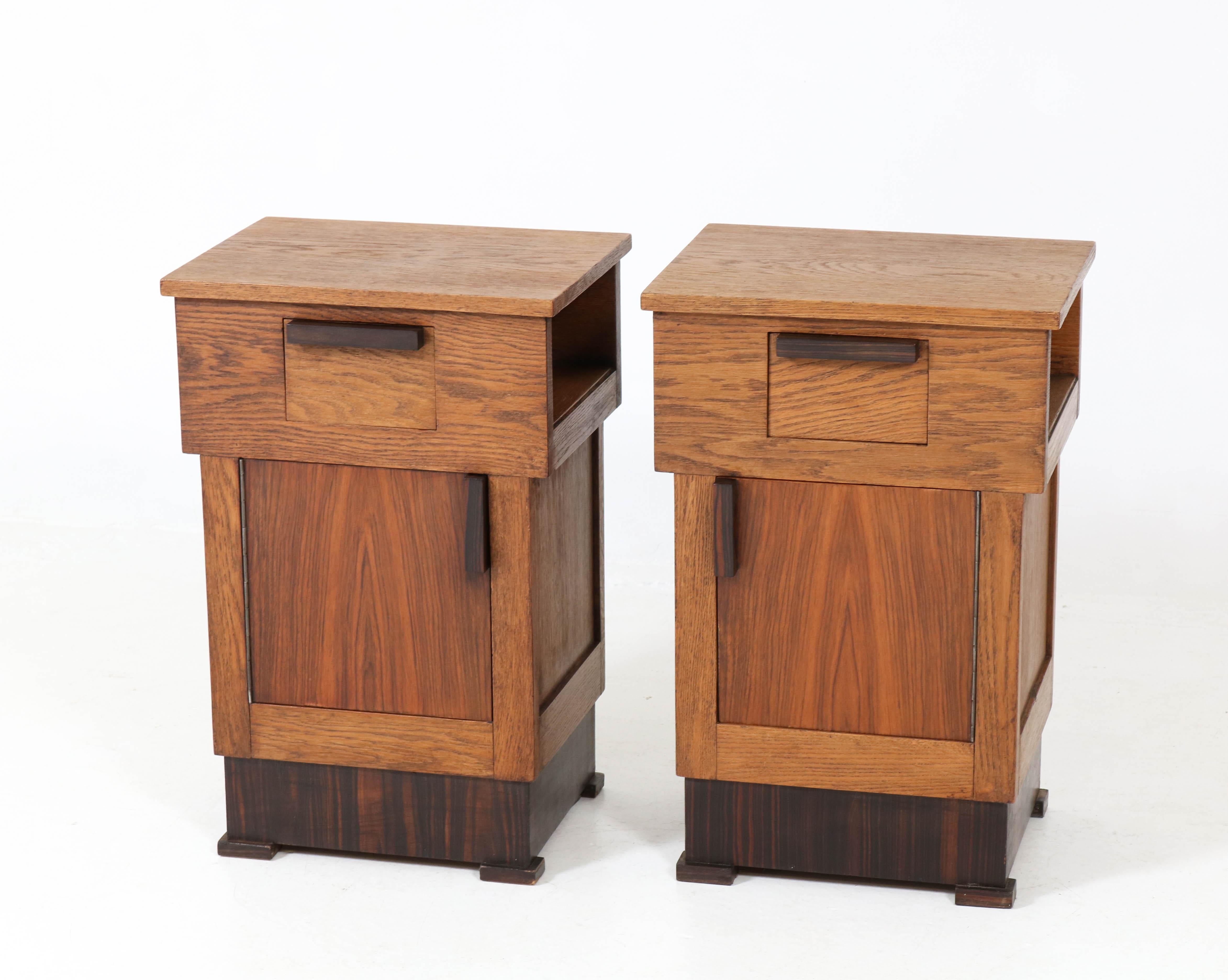 Offered by Amsterdam Modernism:
Wonderful pair of Art Deco Haagse school bedside tables or nightstands.
Solid oak with original solid Macassar ebony handles and veneer lining.
Striking Dutch design from the twenties.
In good original condition with