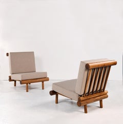 Pair of oak fireside chairs called La cachette, attributed to Charlotte Perriand