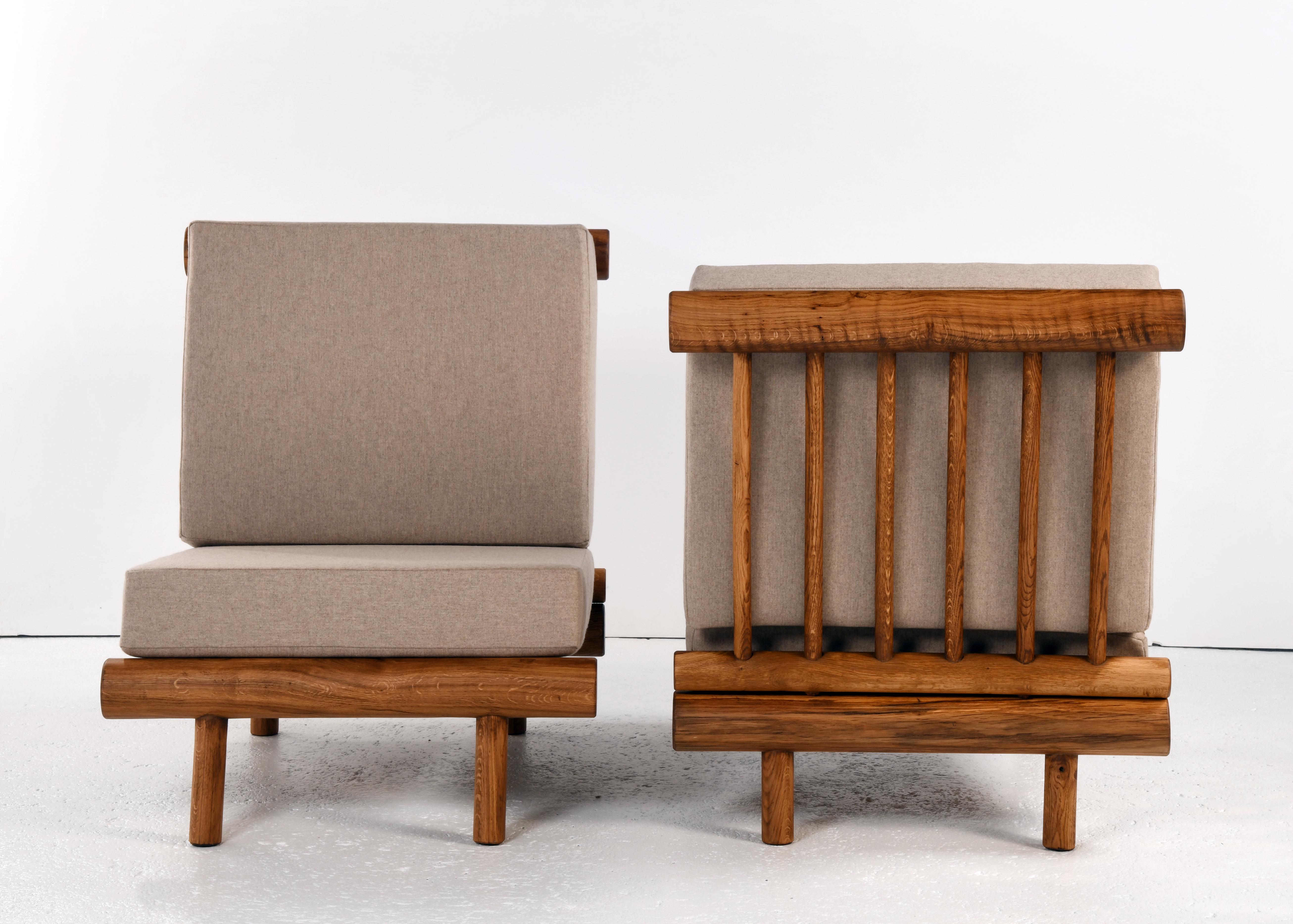 Mid-20th Century Pair of oak fireside chairs called La cachette, attributed to Charlotte Perriand