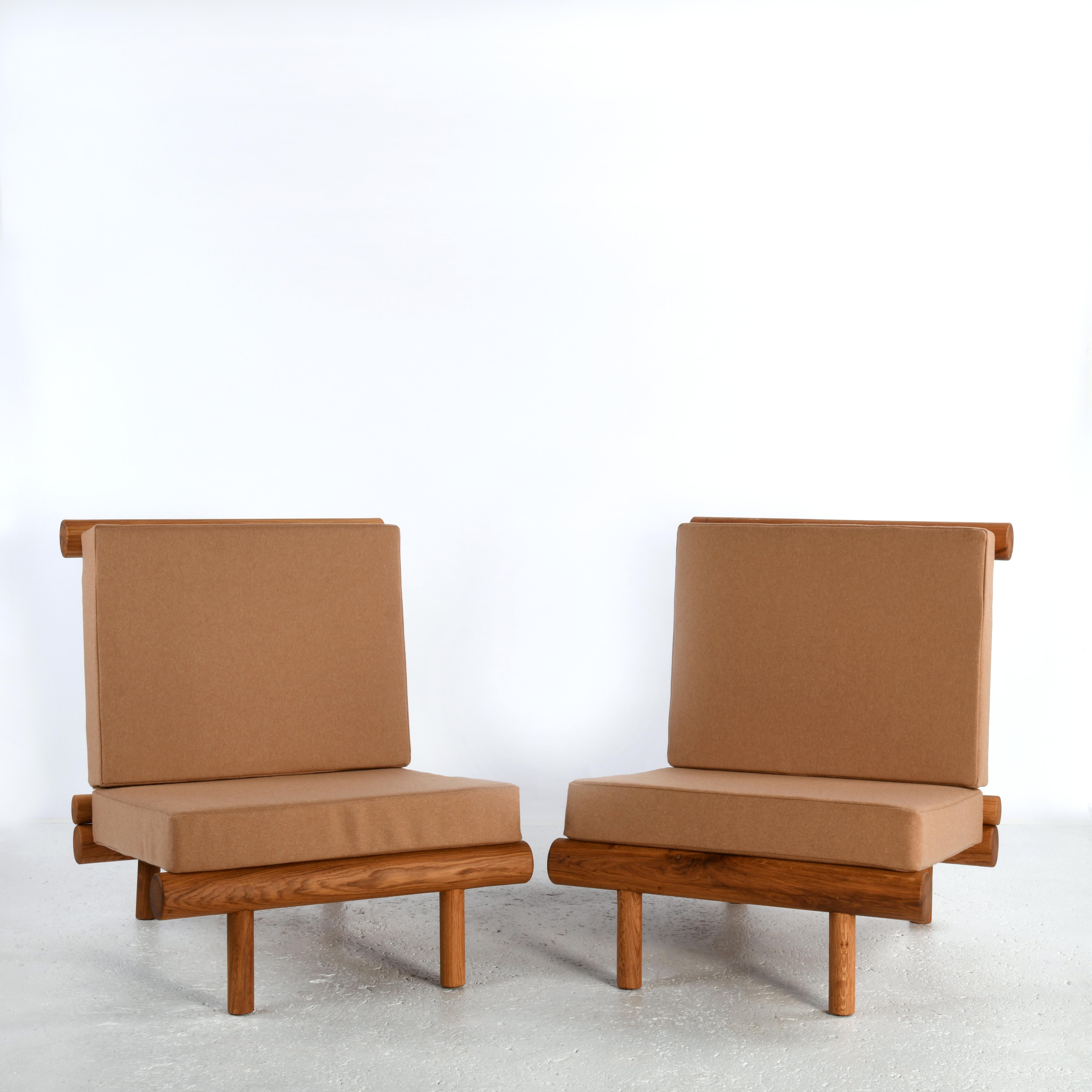 20th Century Pair of oak fireside chairs called La cachette, attributed to Charlotte Perriand