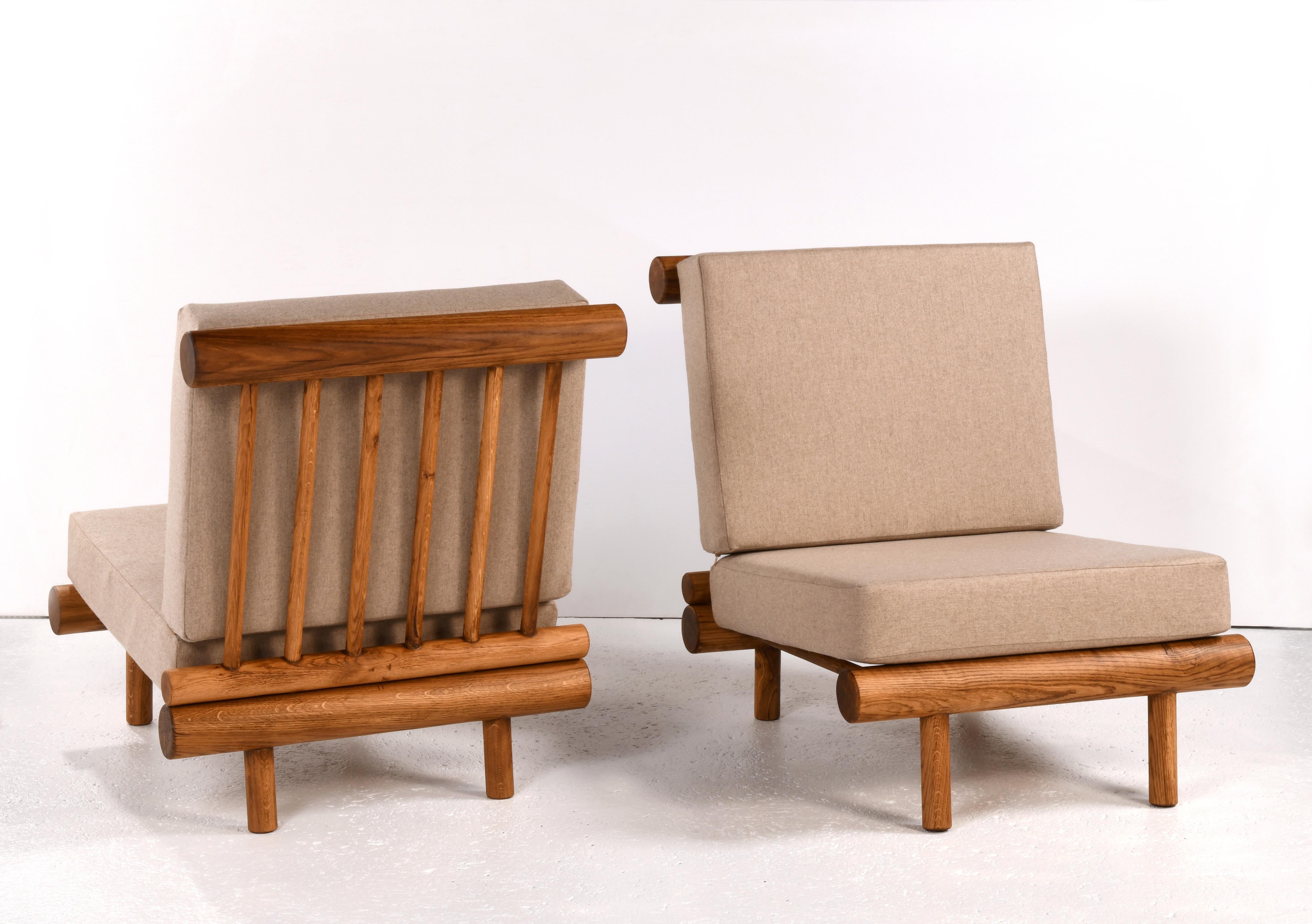 Pair of oak fireside chairs called La cachette, attributed to Charlotte Perriand 1