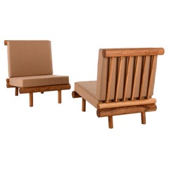 Pair of oak fireside chairs called La cachette, attributed to Charlotte Perriand