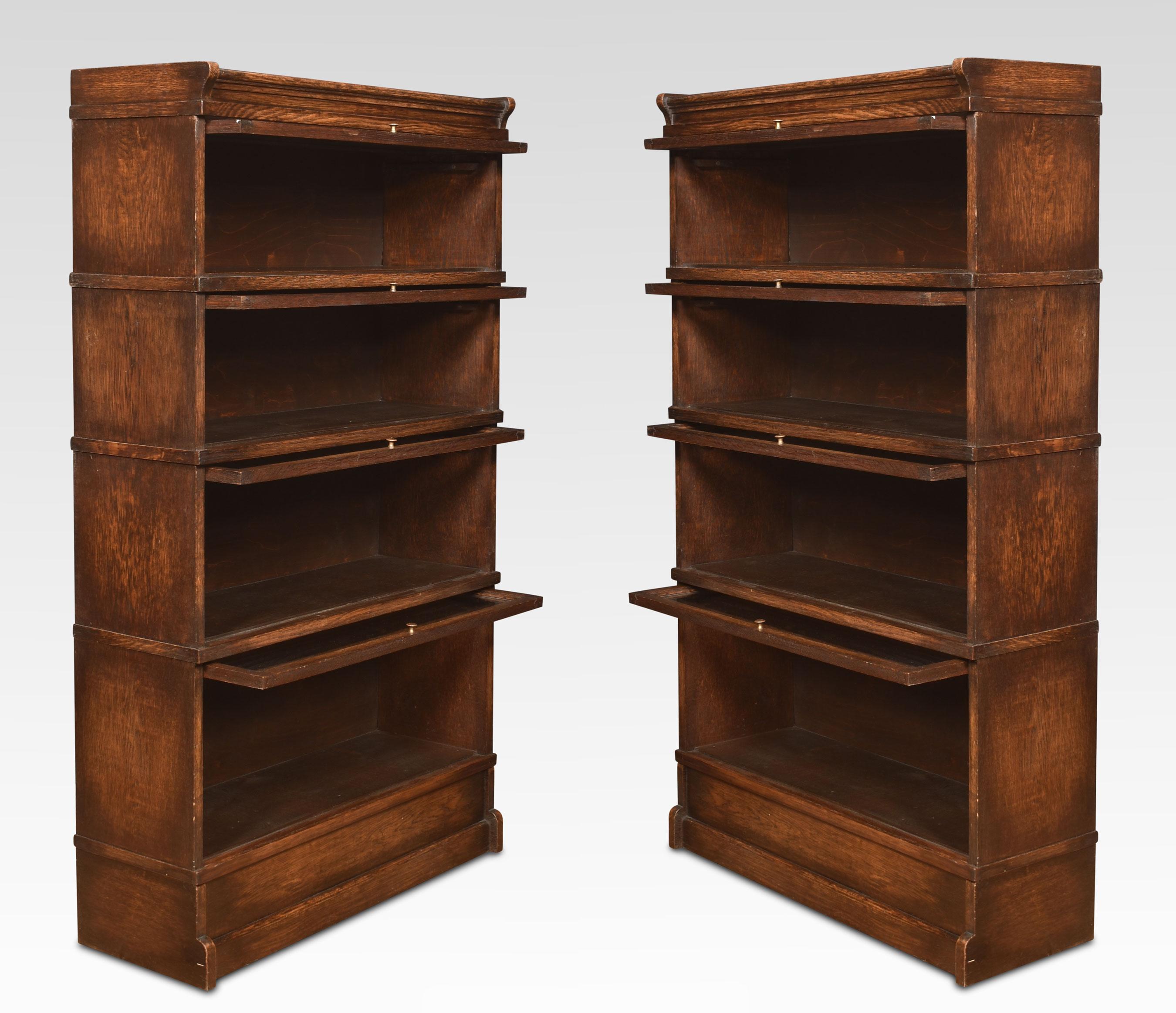 Pair of oak sectional bookcases the moulded top above four graduated sections all having glazed doors. Raised up on plinth base.
Dimensions
Height 58.5 Inches
Width 34.5 Inches
Depth 12 Inches.