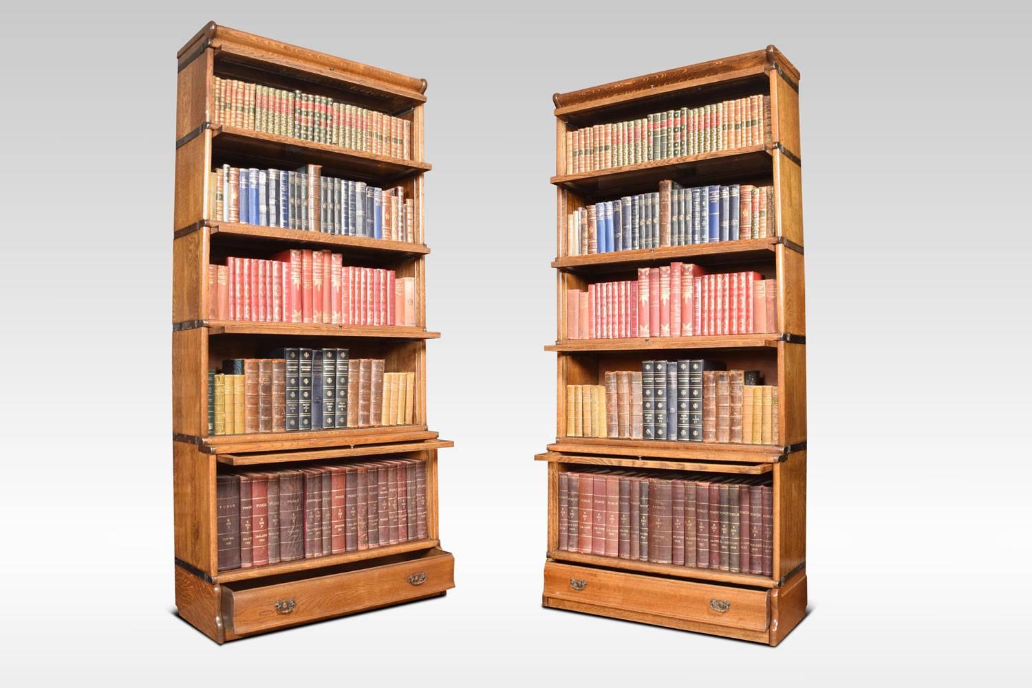 Pair of oak five section bookcases, the moulded top above five section having glazed doors. The base fitted with long draw.
Dimensions
Height 76 inches
Width 34 inches
Depth 15 inches.