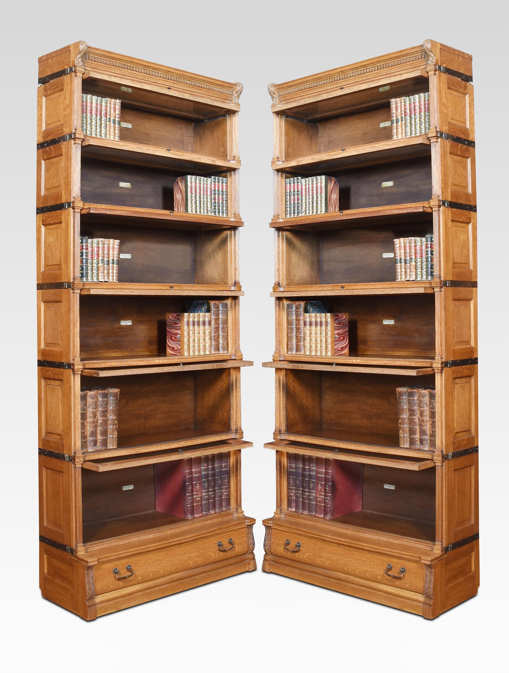 Pair of oak Globe Wernicke sectional bookcases, having six tiers with bevelled glazed doors, between fluted pilasters and having panelled sides, raised on a plinth base with single long drawer.
Dimensions
Height 88 Inches
Width 35.5 Inches
Depth 15