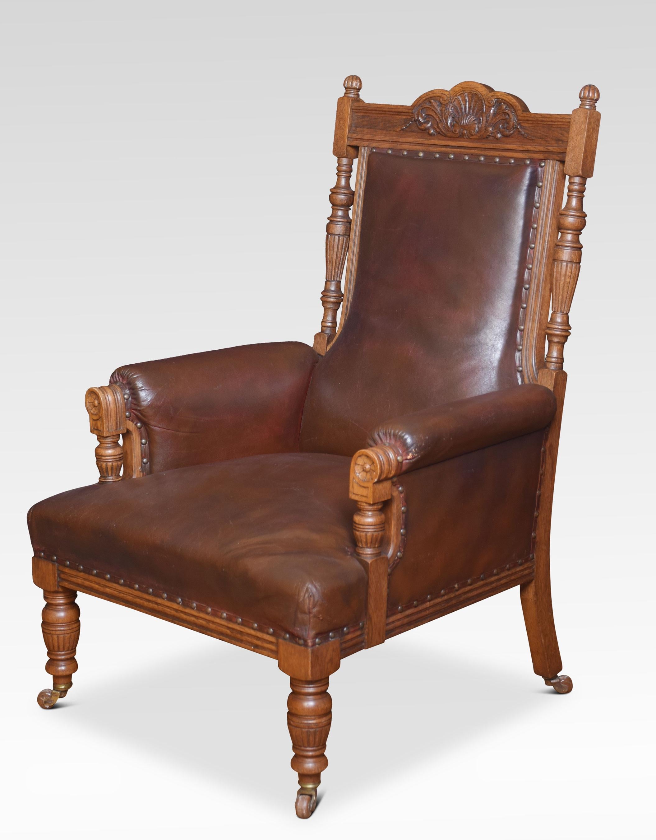 Pair of oak library armchairs. Having shell carved molded top rail above the leatherback and seat. Flanked by open pad arms, all raised on fluted baluster legs with brass cup castors.
Dimensions:
Height 43.5 inches height to seat 16 inches
Width
