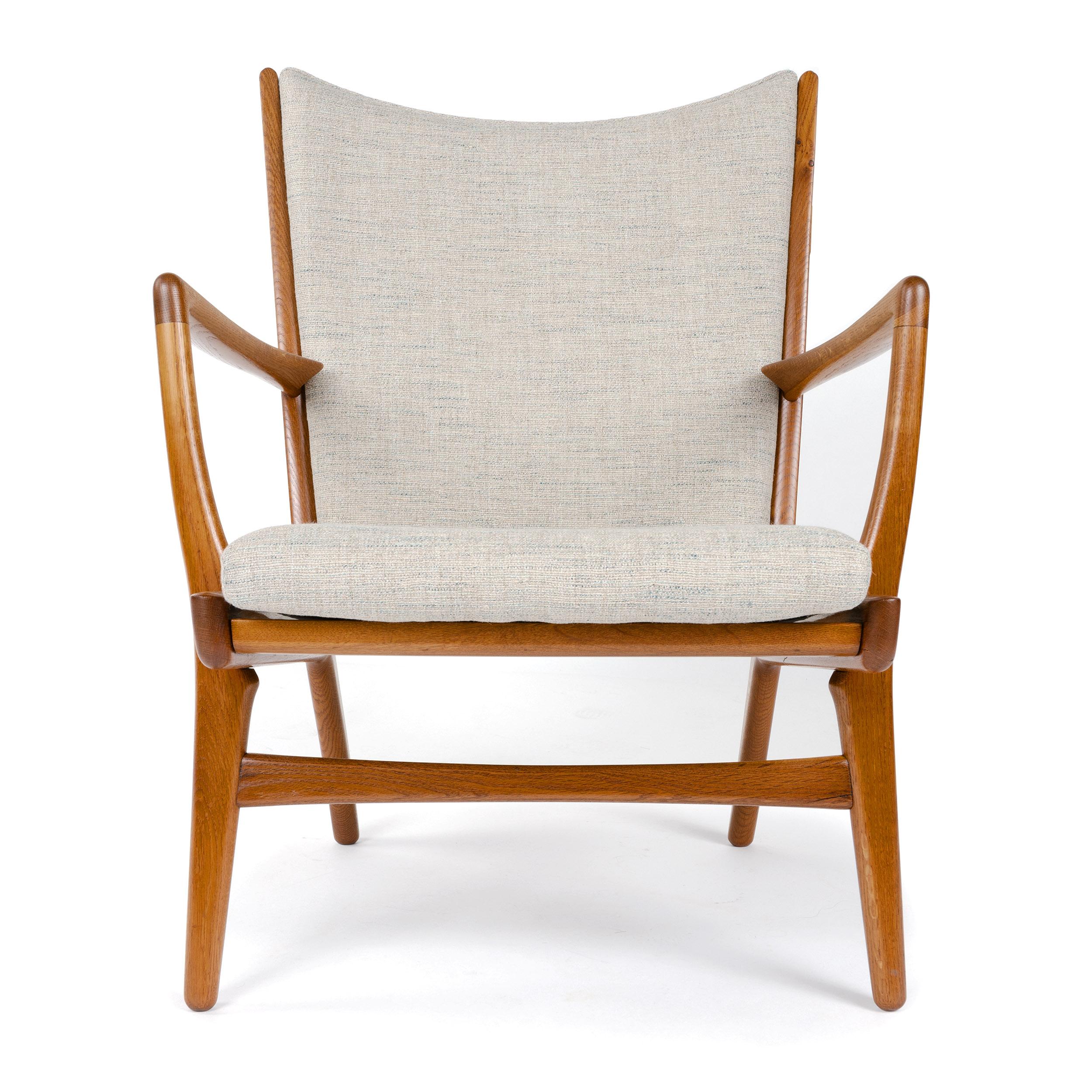 A pair of Danish modern lounge chairs designed by Hans Wegner. Original oakwood frames with upholstery by our workshop. Manufactured by A.P. Stolen, circa 1950s.