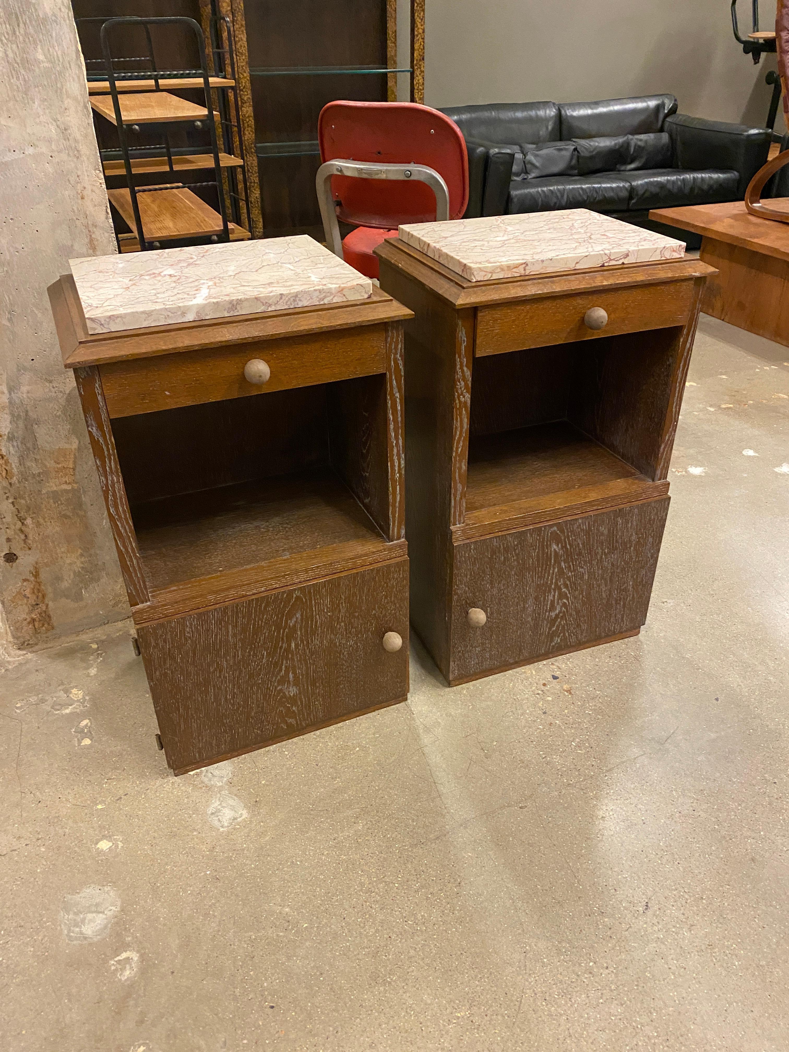 Art Deco night stand pair in cerused oak with blush pink veined marble tops. France, 1930-40's. Cabinet doors on nightstands open on opposite sides, perfect for either side of a bed.