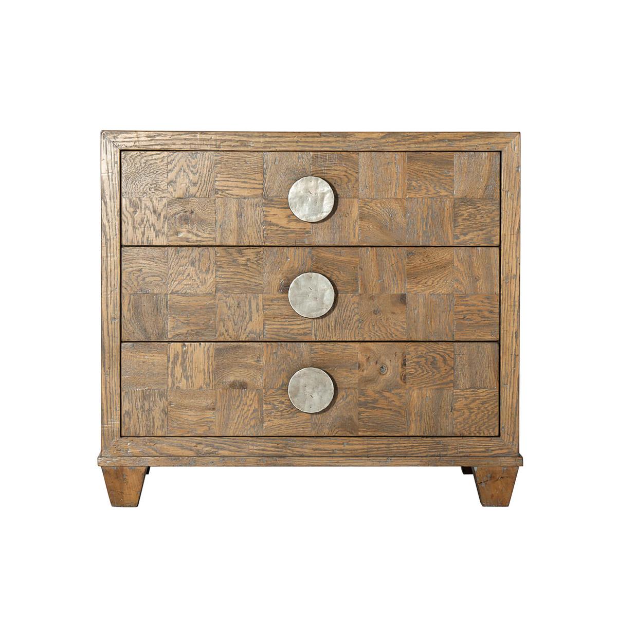 An Oak parquetry nightstand, handcrafted with rustic oak parquetry seen here in our Light Echo Oak finish with picture frame parquetry top and sides. This nightstand includes three checkered parquetry soft-close drawers, vintage textured metal disc