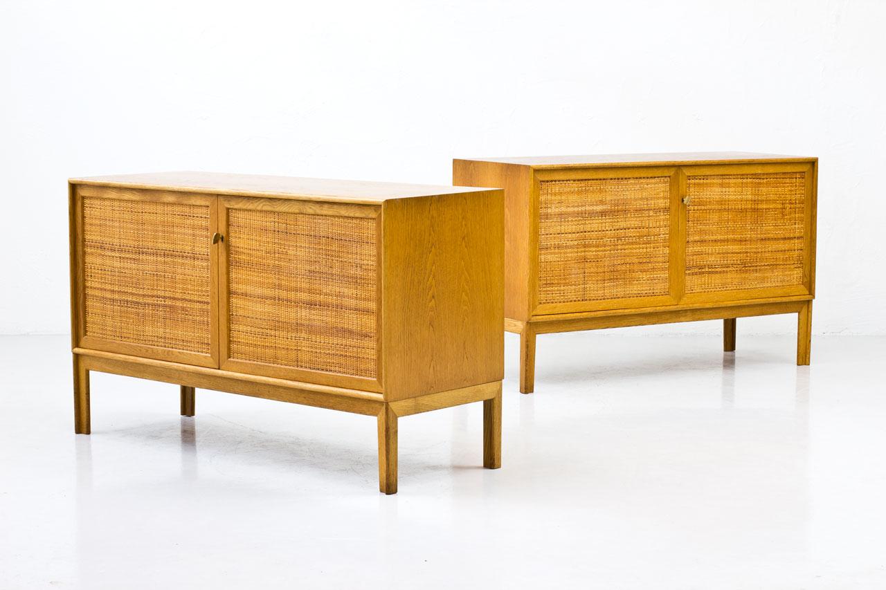 Pair of sideboards designed by Alf Svensson for Bjästa Möbelfabrik in Sweden during the 1960s. 
Made from oak with two doors panel covered by rattan webbing. Brass key. 
Inside in birch with adjustable shelves. Stamped by maker. 
Length of each