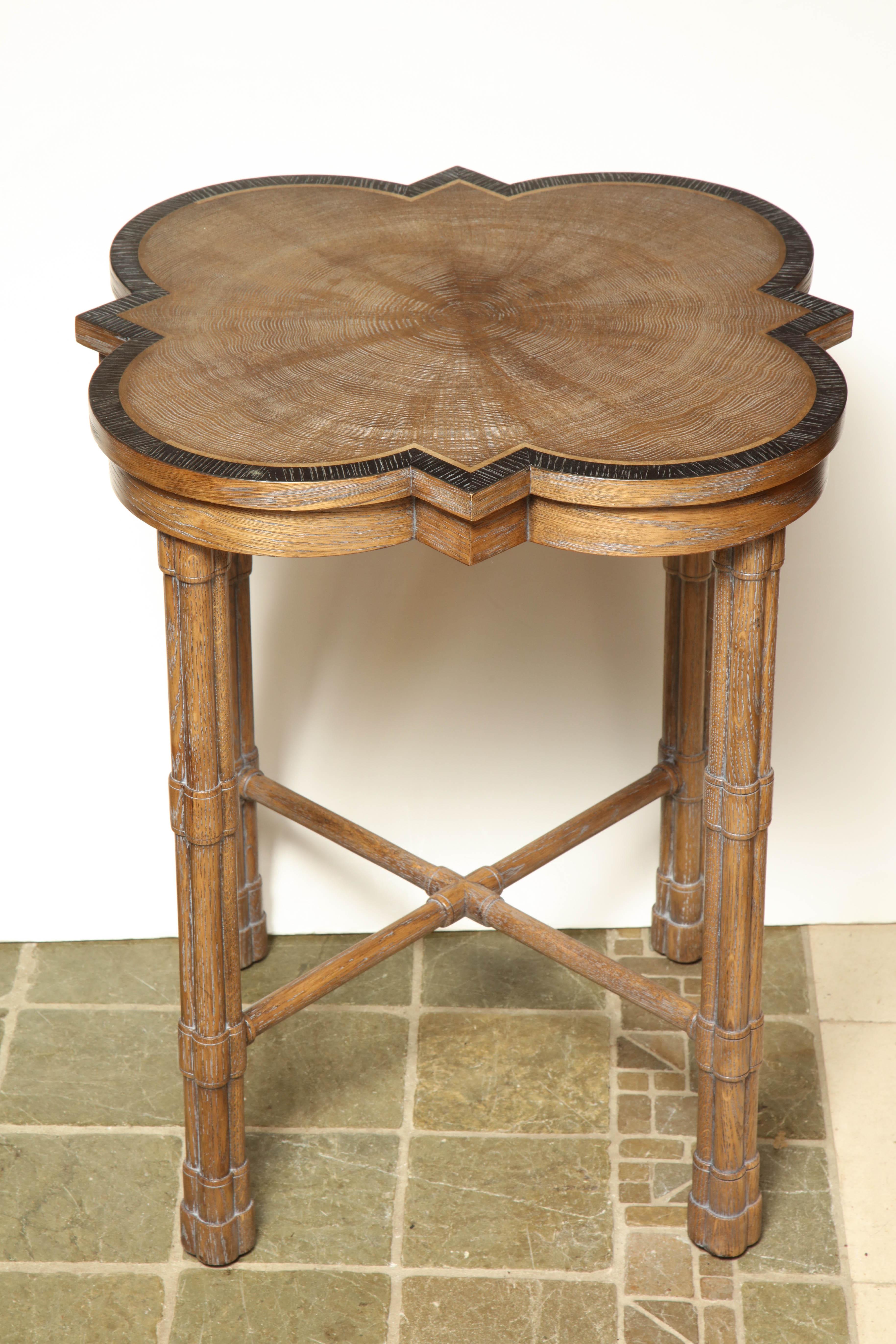 Pair of transitional English heart oak veneered side tables in the George II taste, with crossbanded tops on cluster column legs with an X stretcher.