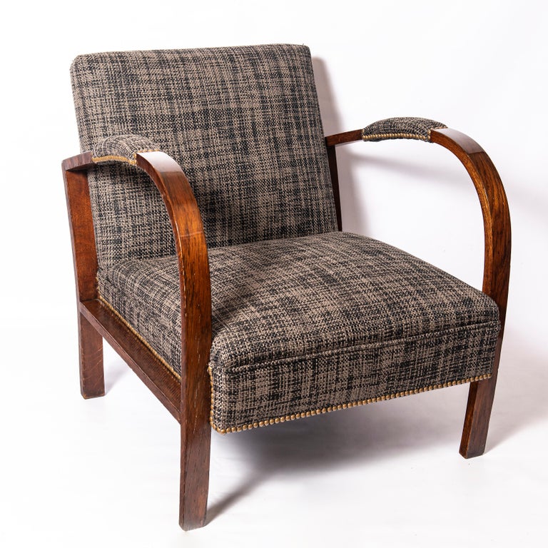 Pair of oakwood and fabric armchairs. Art Deco period, France, circa 1940.