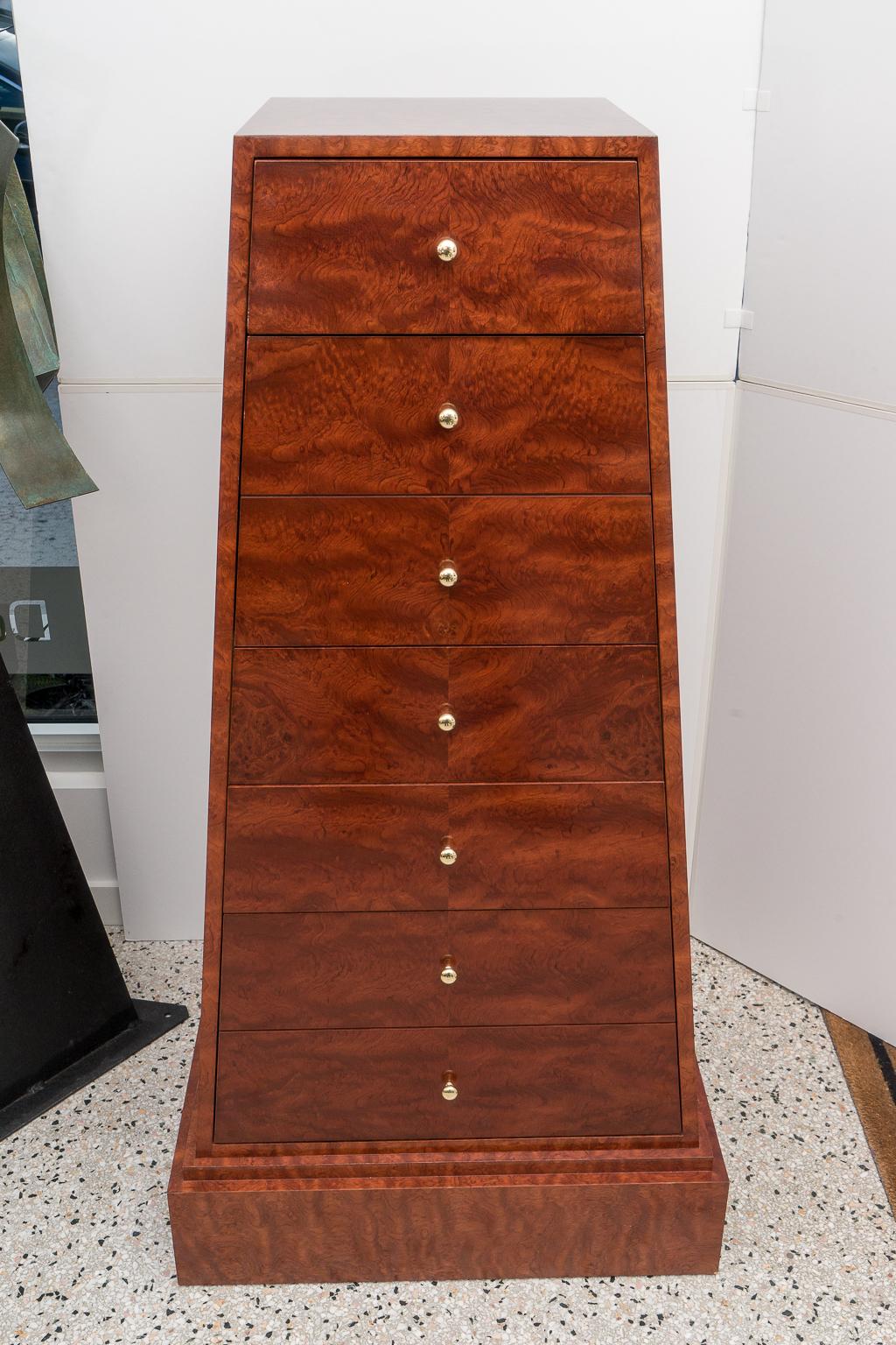 This stylish set of custom made obelisk-form semainier date to the 1980s and were acquired from a Palm Beach estate. The burl wood has an exotic grain and it gives the clean, simple lines of the cabinets a bit of drama. 

Note: One of the cabinets