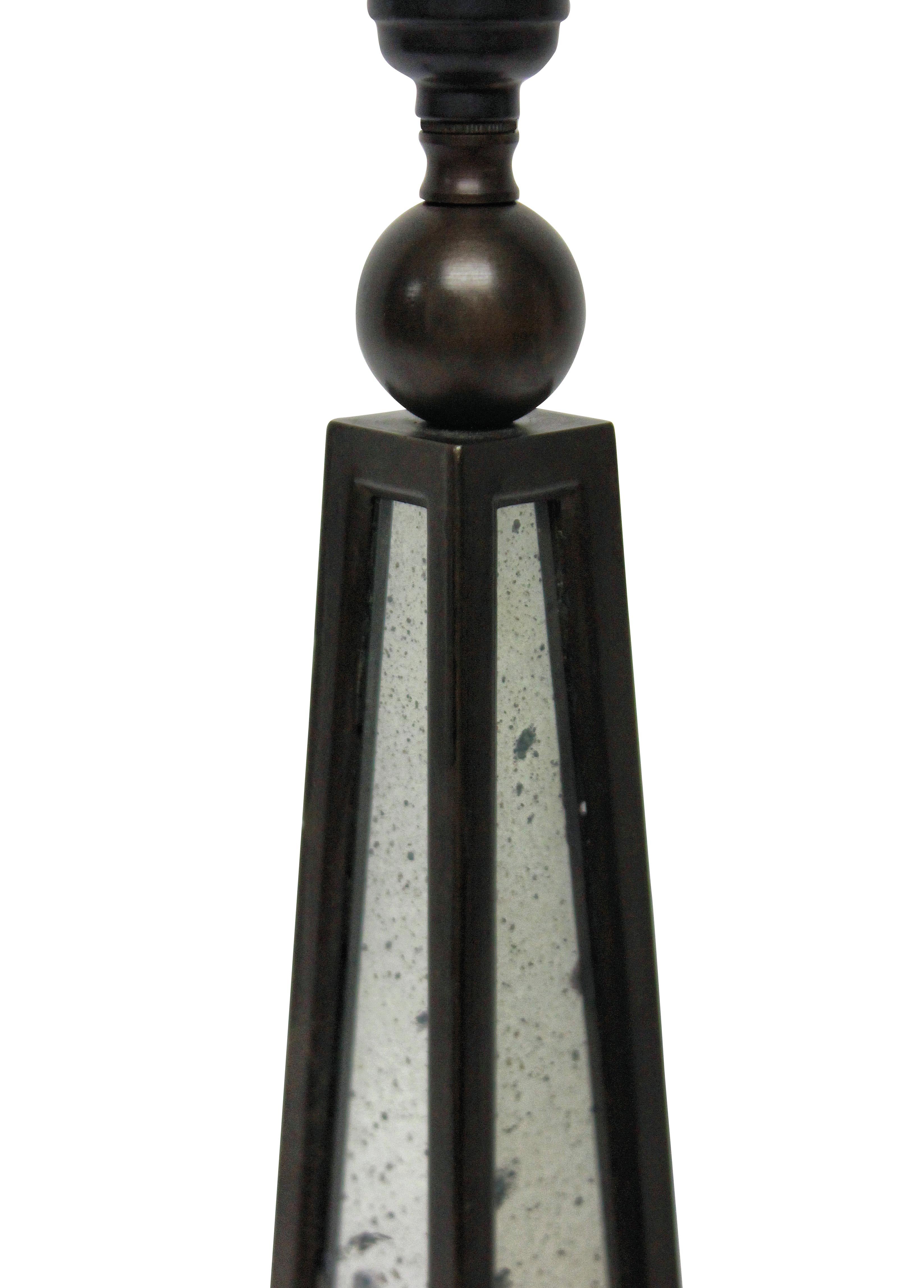 A pair of English bronzed obelisk lamps with distressed mirror panels.