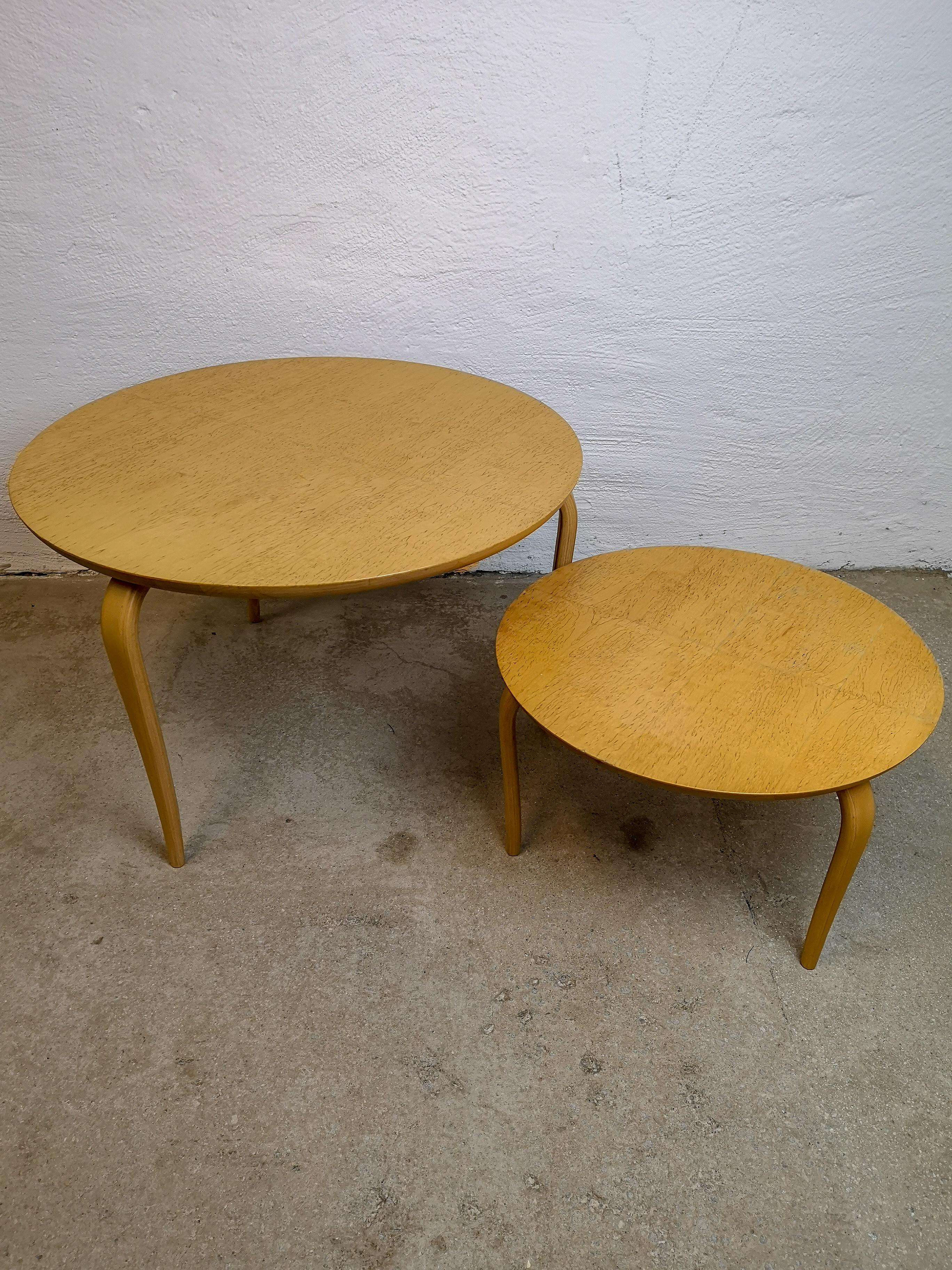 Two nicely designed tables manufactured by Dux in Sweden, early 1980s. The design of Bruno Mathsson makes the tables Slender legs work with the top of the table made in Birch and Karelian birch.

Good condition. 

Measures: H 42, D 65 cm and H