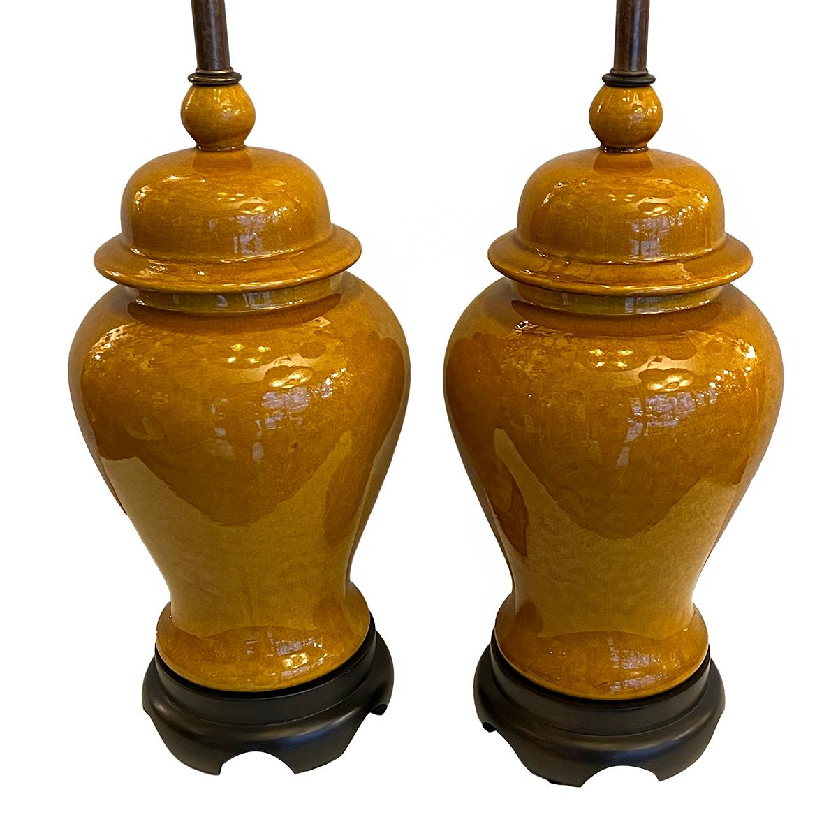 Pair of circa 1940’s French vintage ochre porcelain lamps mounted on wooden bases.

Measurements:
Height of body: 18?
Diameter: 8.25?.