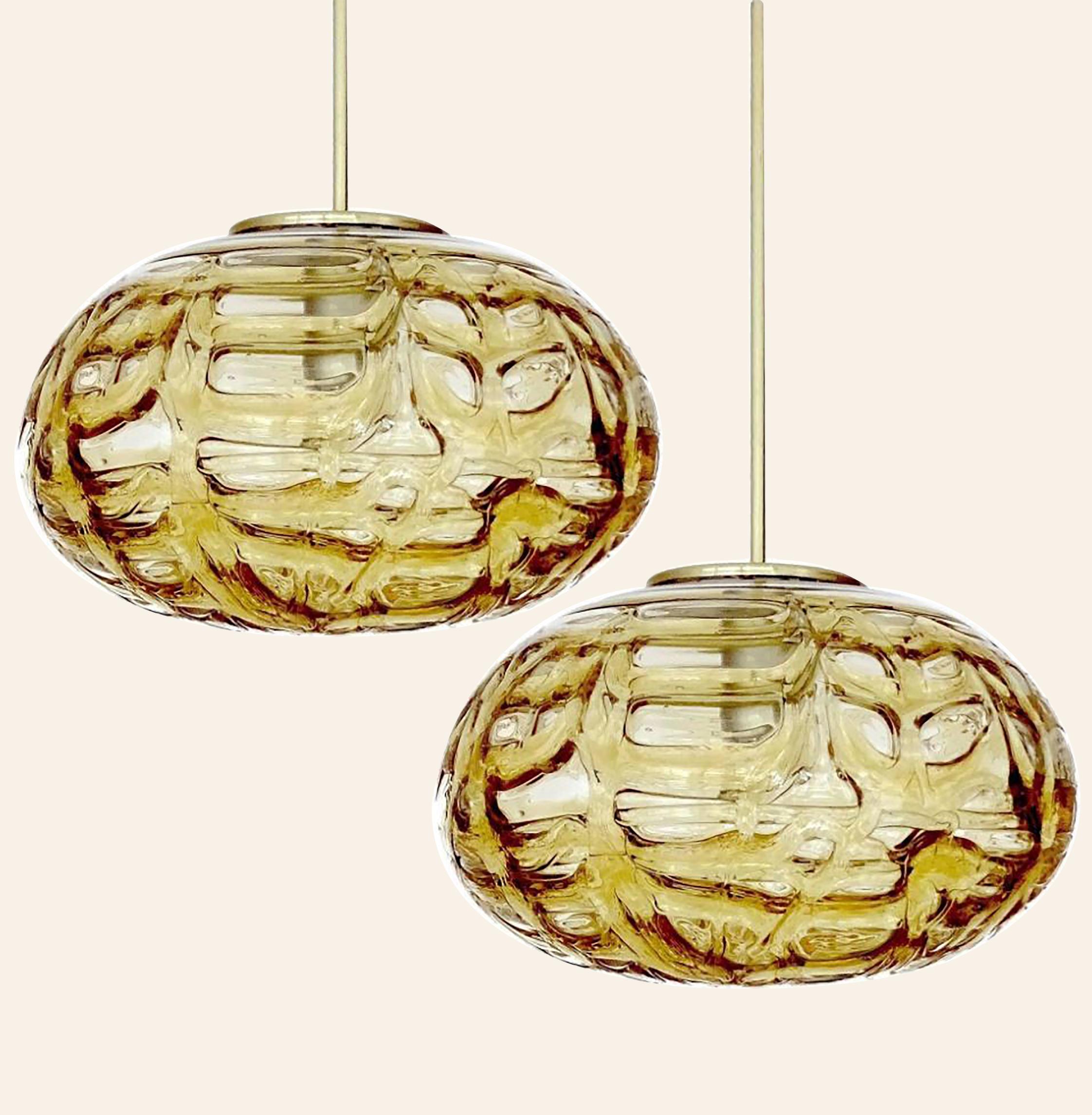 Doria ceiling light with an oval Murano amber glass and brass glass ball. Heavy quality, gives a wonderful light effect when it is on. Amber glass, brass. Period: 1970
Dimensions: H 7.5