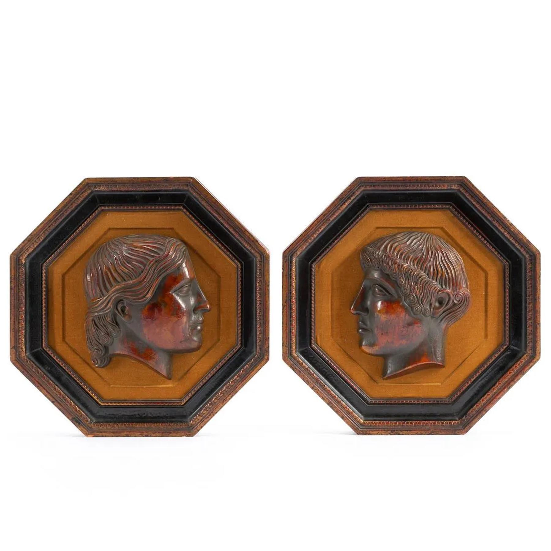 Pair of Octagonal framed 'Pompeiian Red' pottery Roman Medallions 
Each one a well executed glazed pottery male profile portrait medallion, with a vintage custom octagonal frame with velvet mat. 
Medallions alone measure 6' W x 7.5