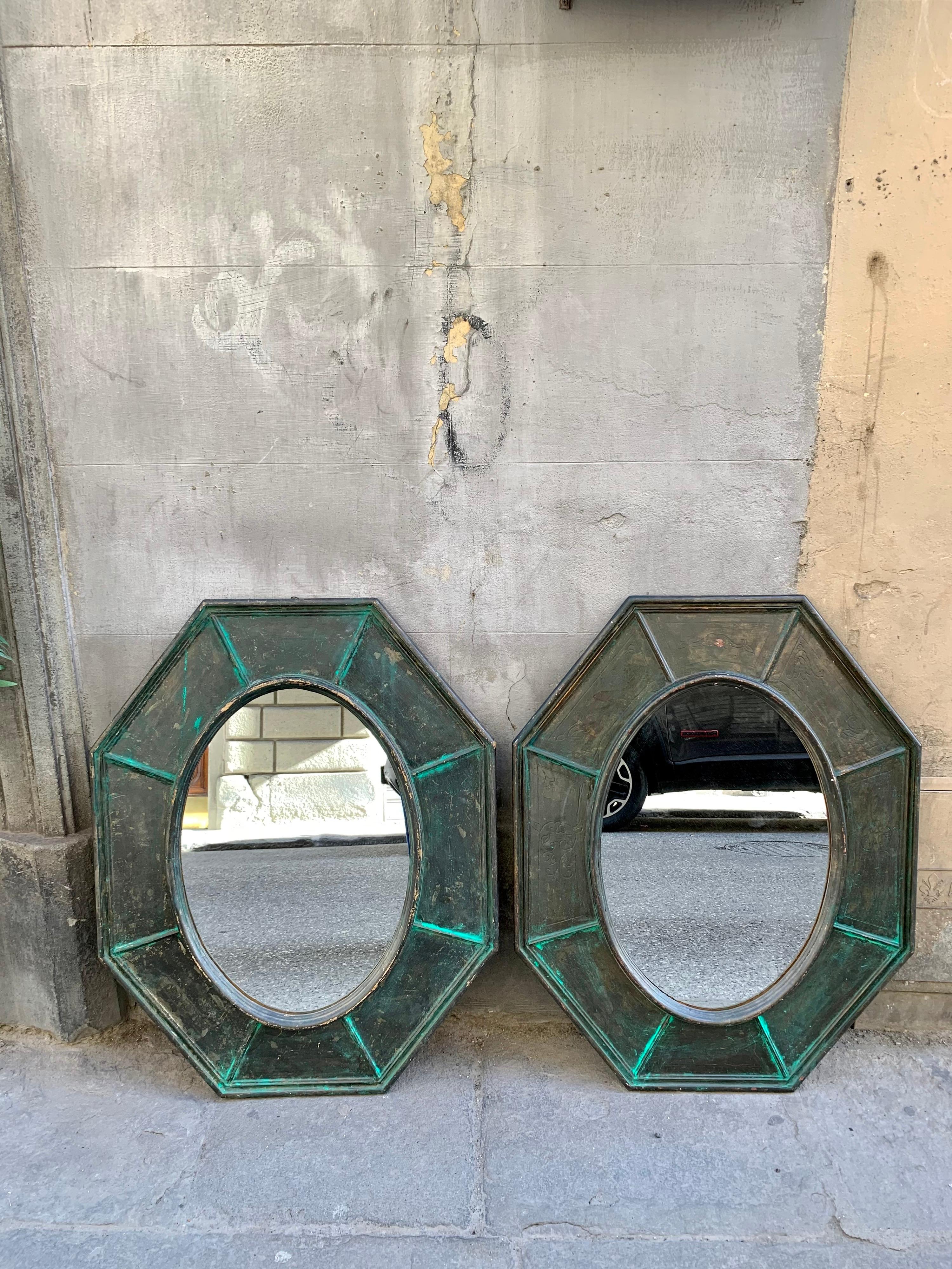 Pair of octagonal mirrors in green wood, decorated with a metallic effect. 
There are small scratches in the paint which increase the flavor.