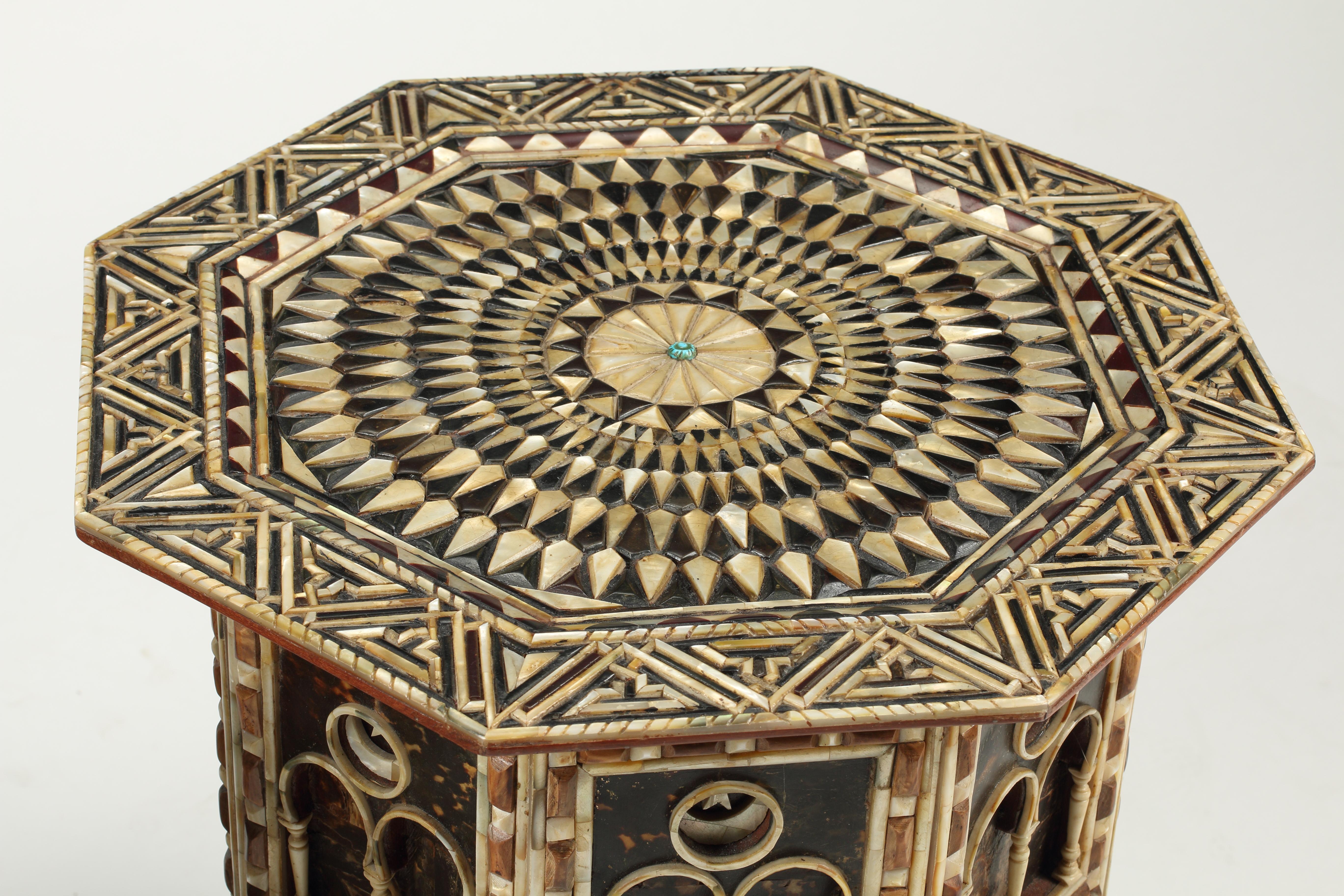 A unique pair of Levantine octagonal side tables featuring a meticulous attention to detail to intricately carved and inlaid mother of pearl, bone, and tortoiseshell design. 
While most levantine tables are inlaid into a wood veneer, this pair is