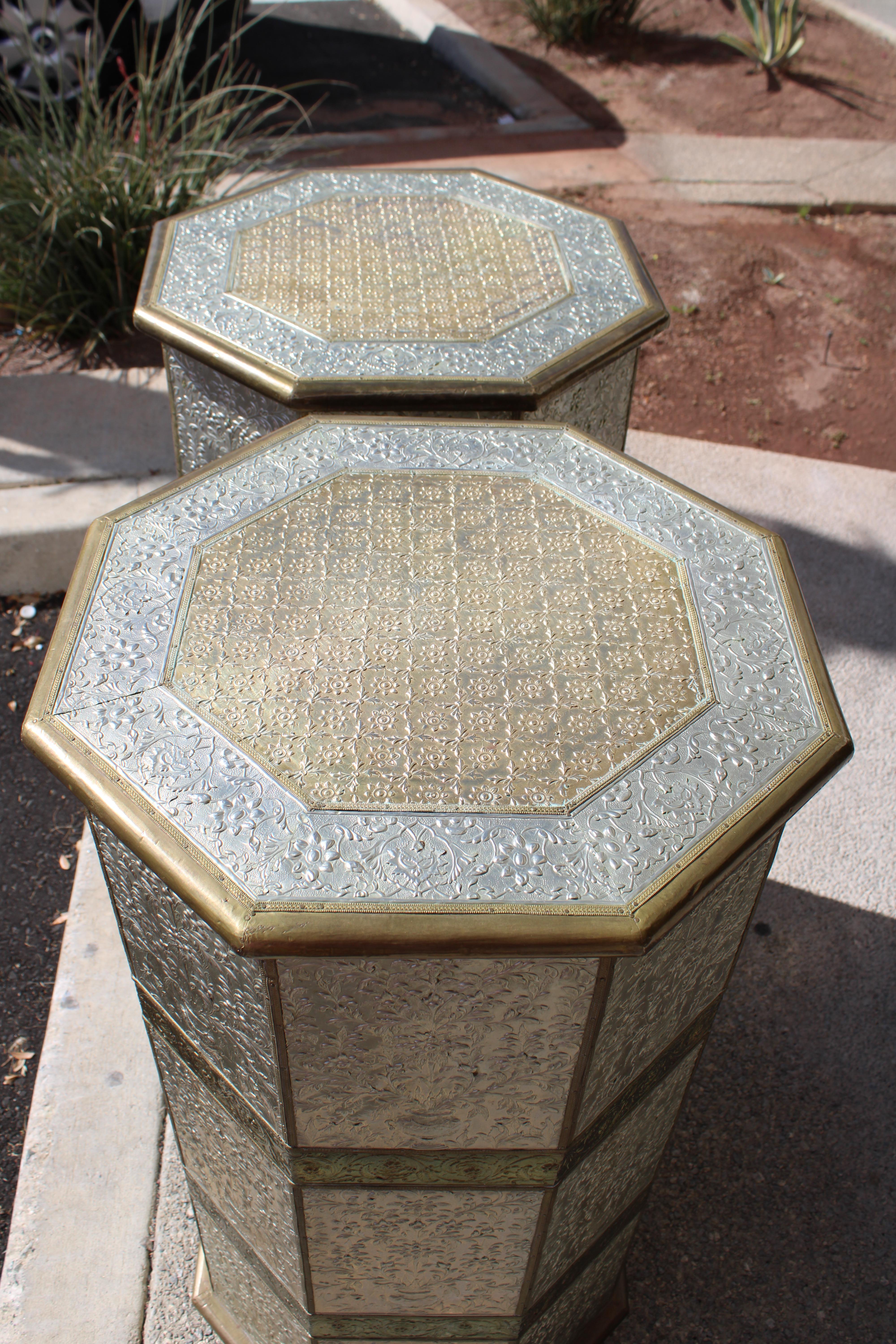 Pair of octagonal wood pedestals with applied brass and tin repoussé panels. Each panel measures 18.25