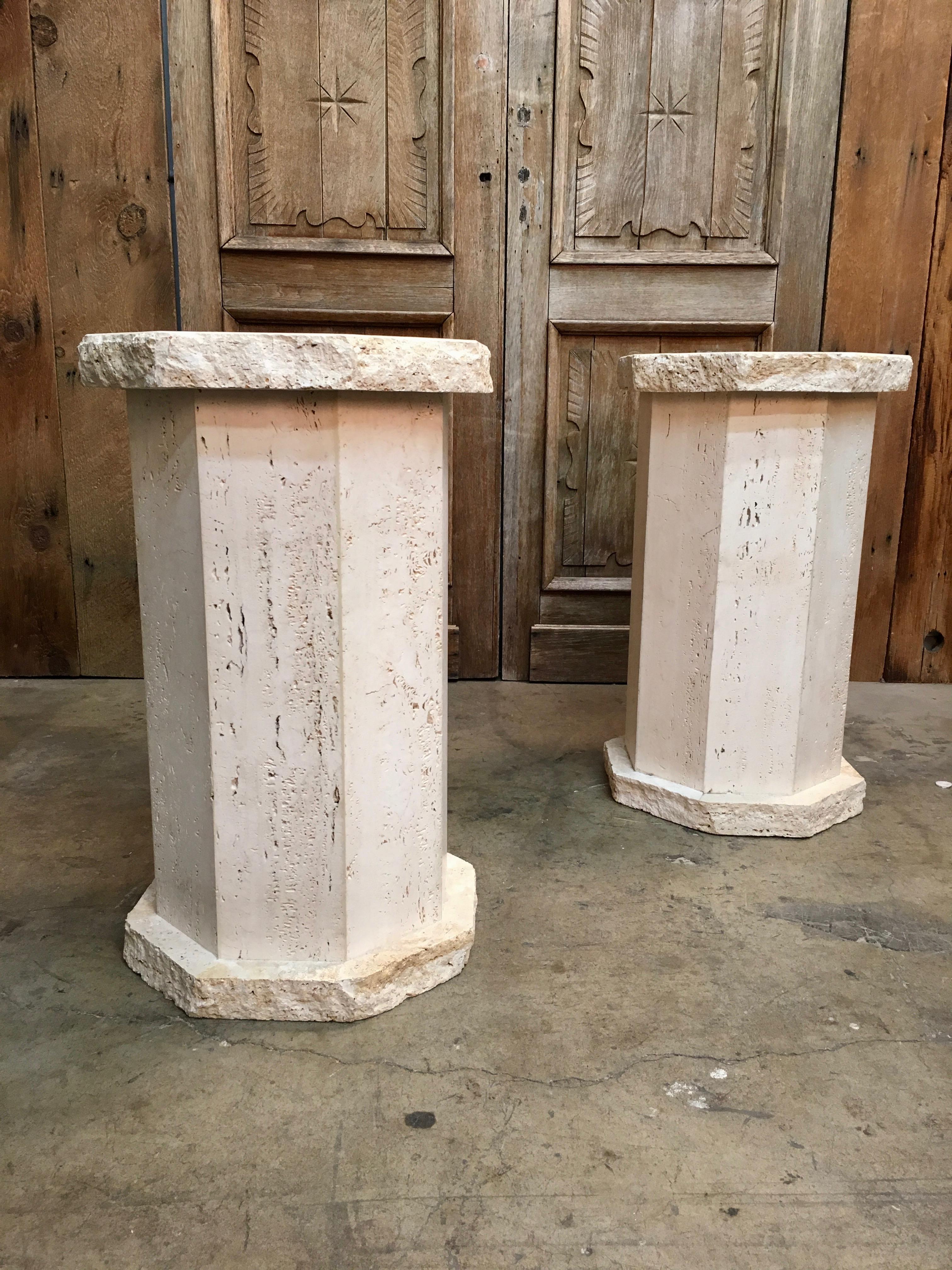 Pair of rustic Travertine pedestals can be used as table base for glass top or displaying of sculptures and lamps.