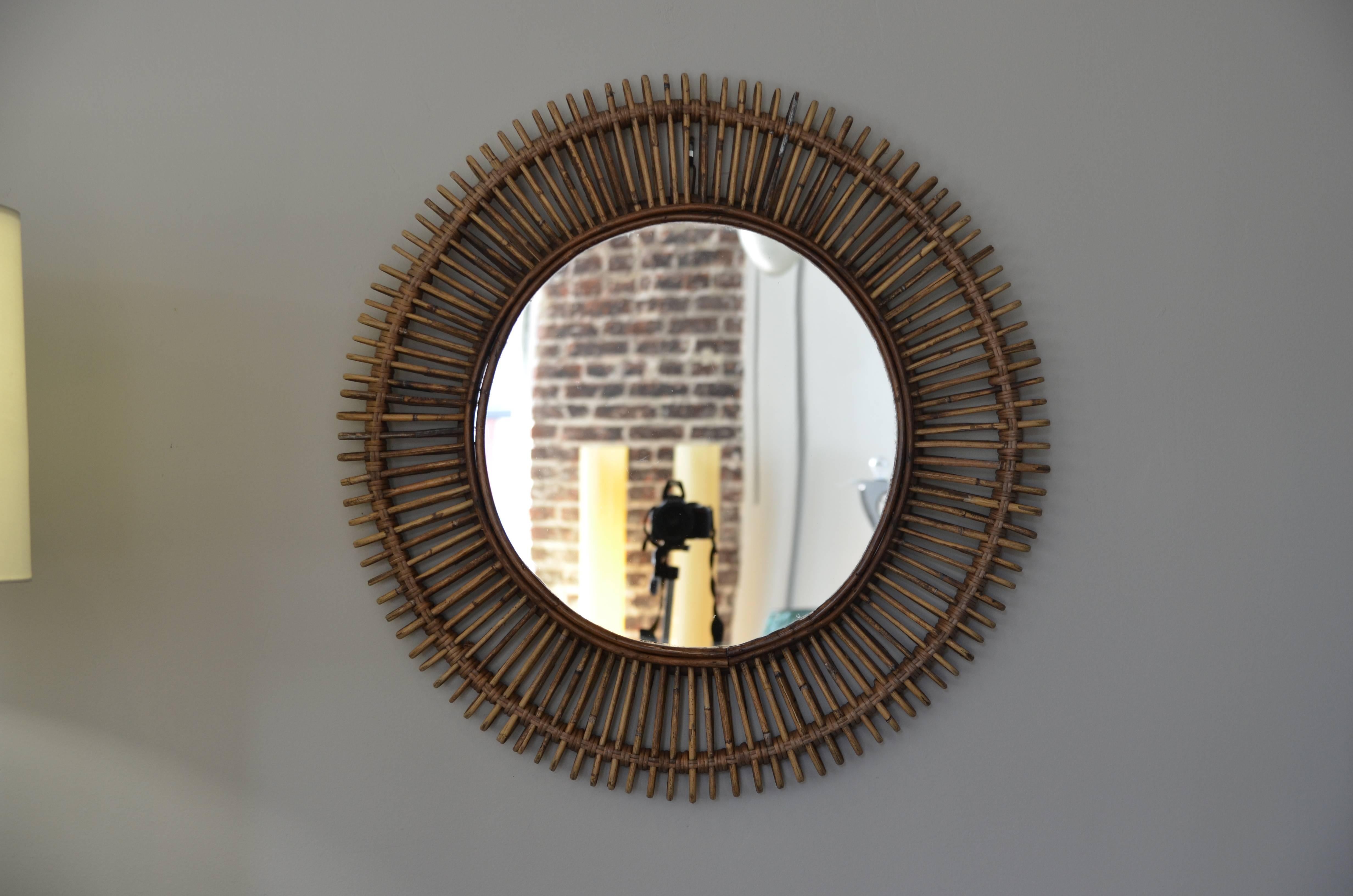 Pair of 'Oculus' round rattan mirrors by design Frères. Flat mirror inserted into an intricate rattan frame.