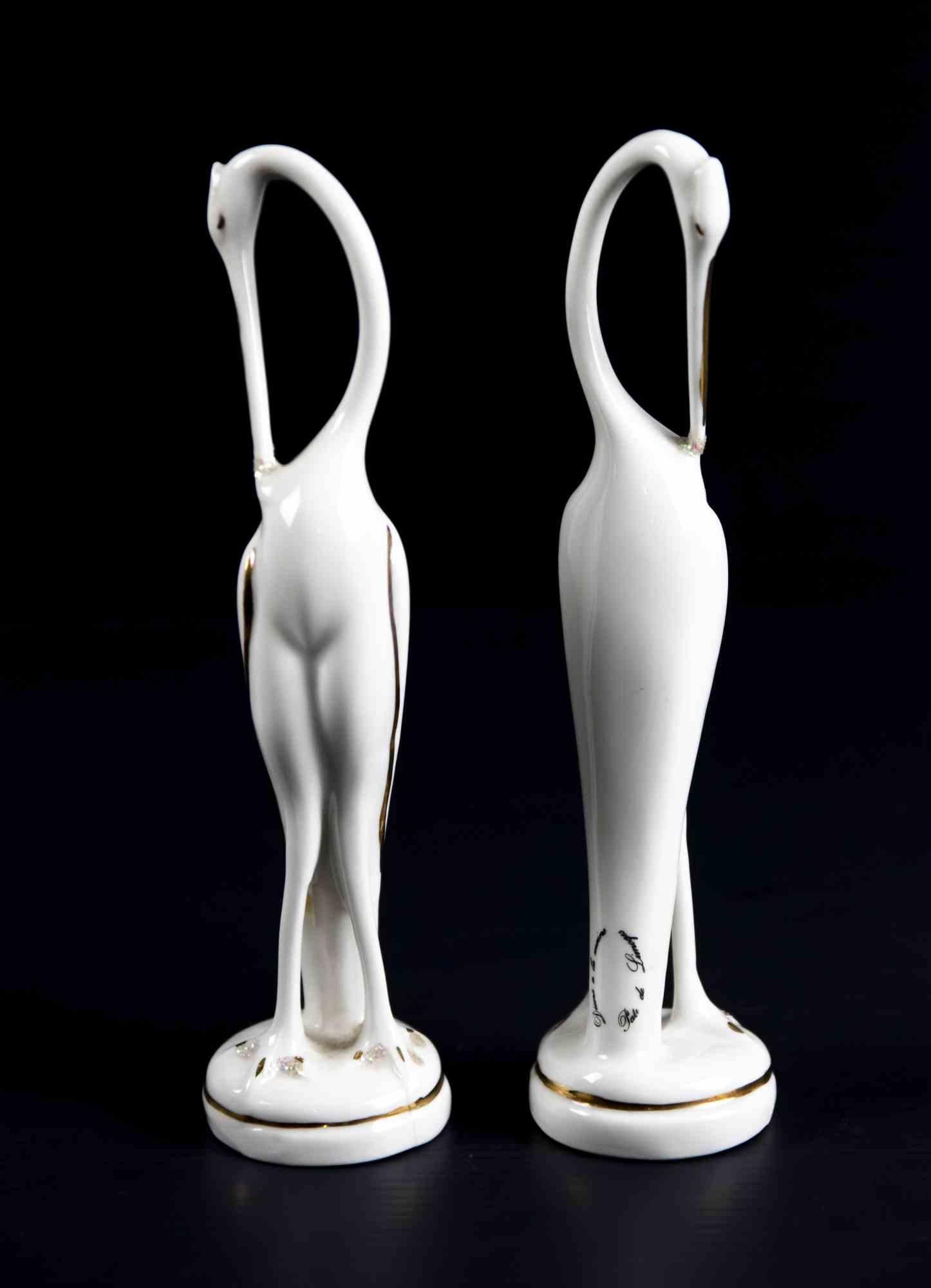 Pair of of Porcelain Flamingos is an original decorative object realized in the 1970s by Limoges manufacture.

Hand made by Limoges Laboratories (as reported on the back).

Refined with gilded decorations.