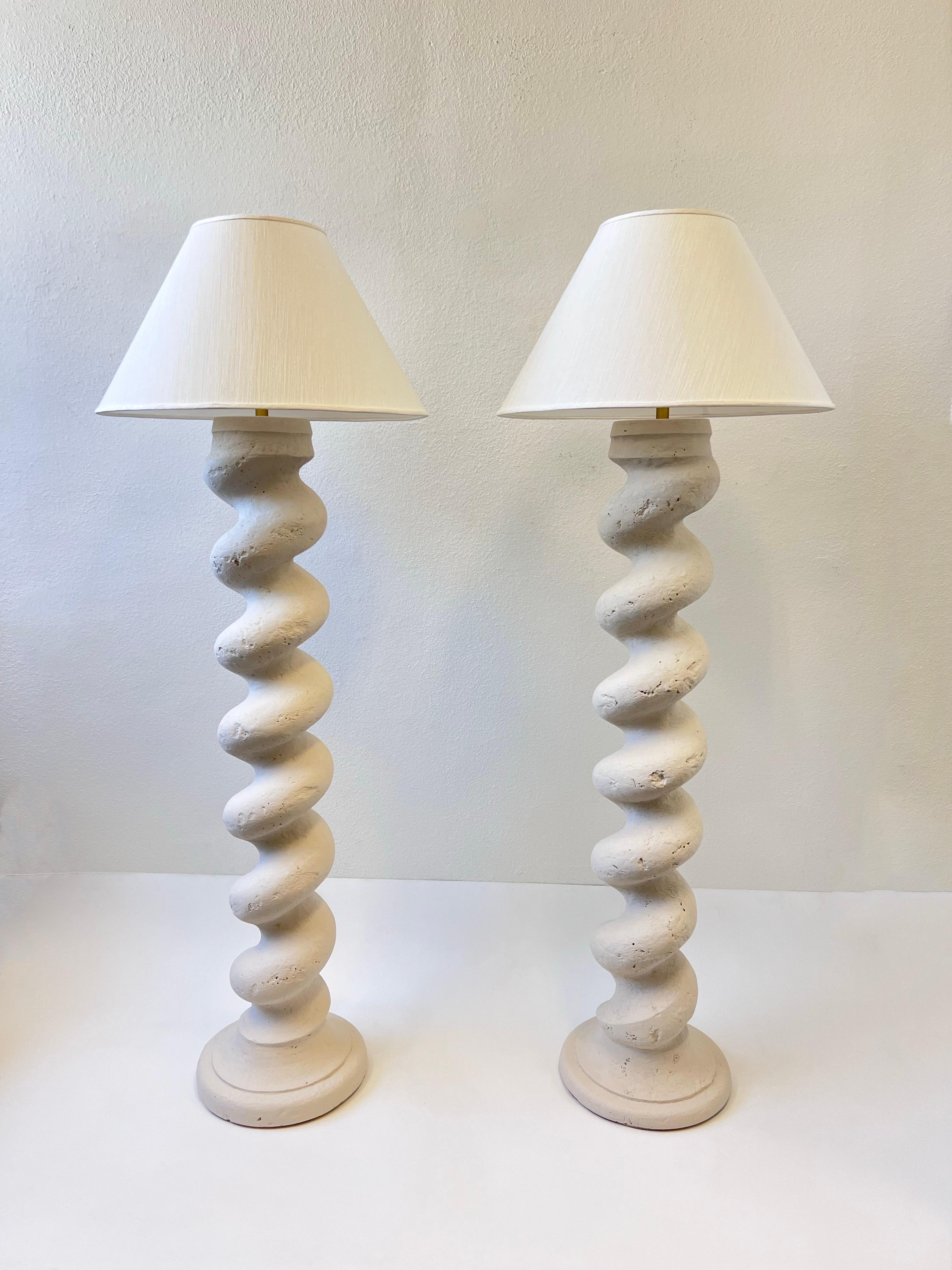 Pair of 1980’s off white plaster and brass spiral form column floor lamps by Michael Taylor. 
Taylor was known for his all white interiors.  

Newly rewired and new white silk shades. 
They take one 100w Max Edison bulb. 

Measurements: 
72.25”