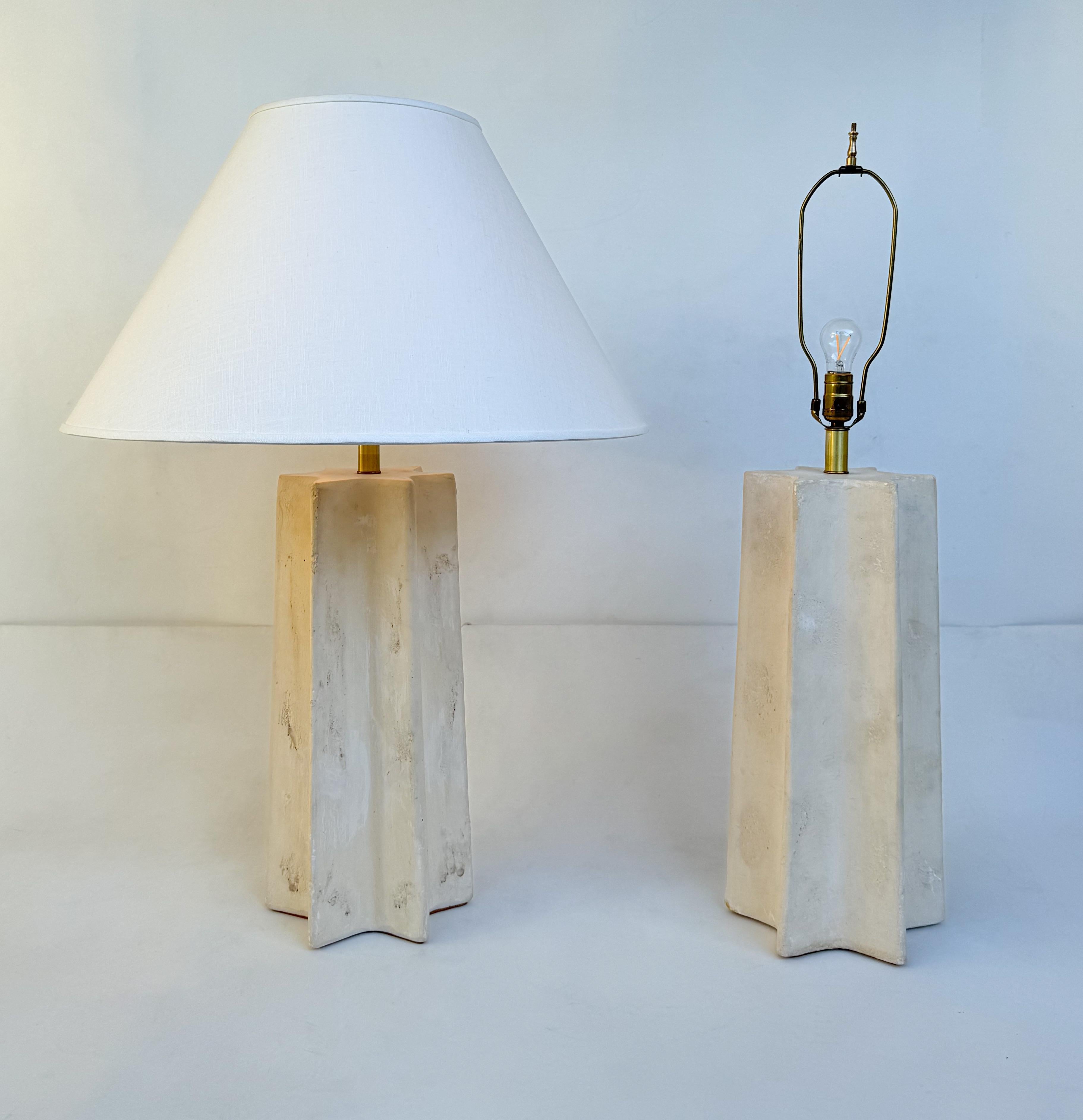 1970’s Pair of off white  star shape cast plaster lamps by Michael Taylor. 
The lamps are wired for US, it takes one 100w Max bulb. 
New vanilla linen shades. 
Lamps are available without shades. 

Measurements: 35” High, 10” Diameter at base, 26”