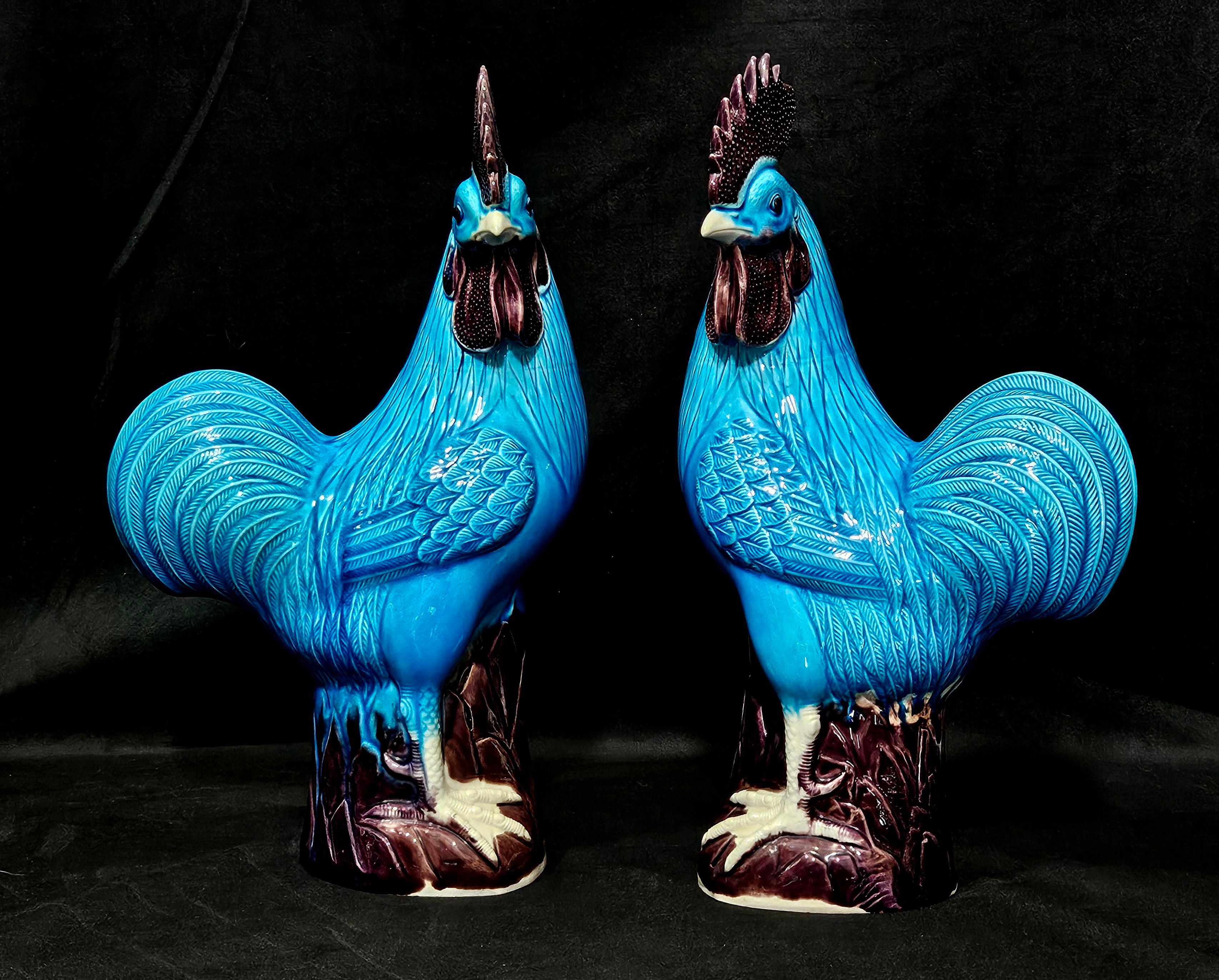 A large pair of Chinese turquoise glazed porcelain roosters with purple combs, circa 1920.





