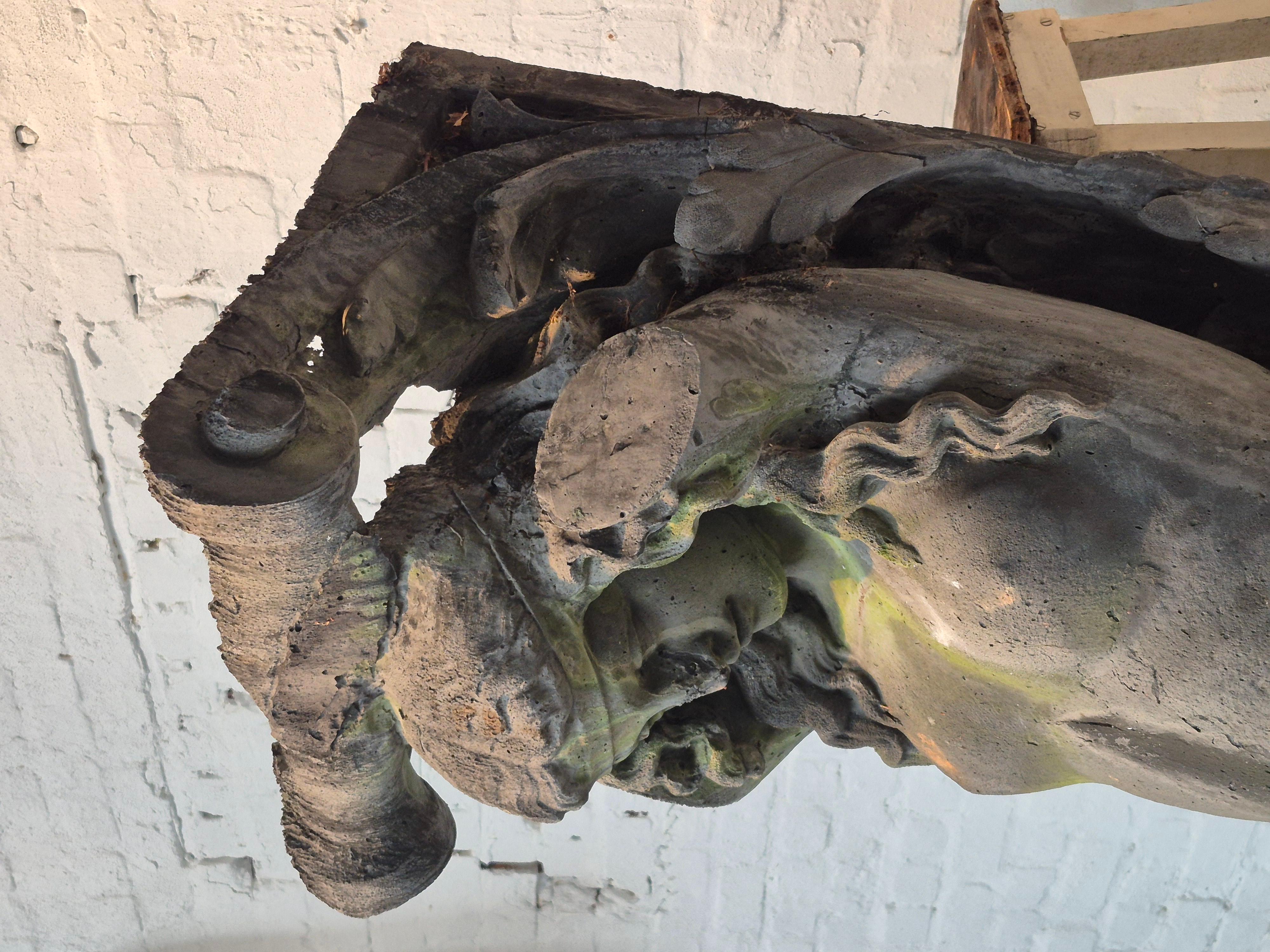 Pair of old cariatides depicting two mythological figures. Made in the 1960s as theatre props. Material is a mix of cement and plaster and with a metal structure inside. Weathered patina from hanging outside.
