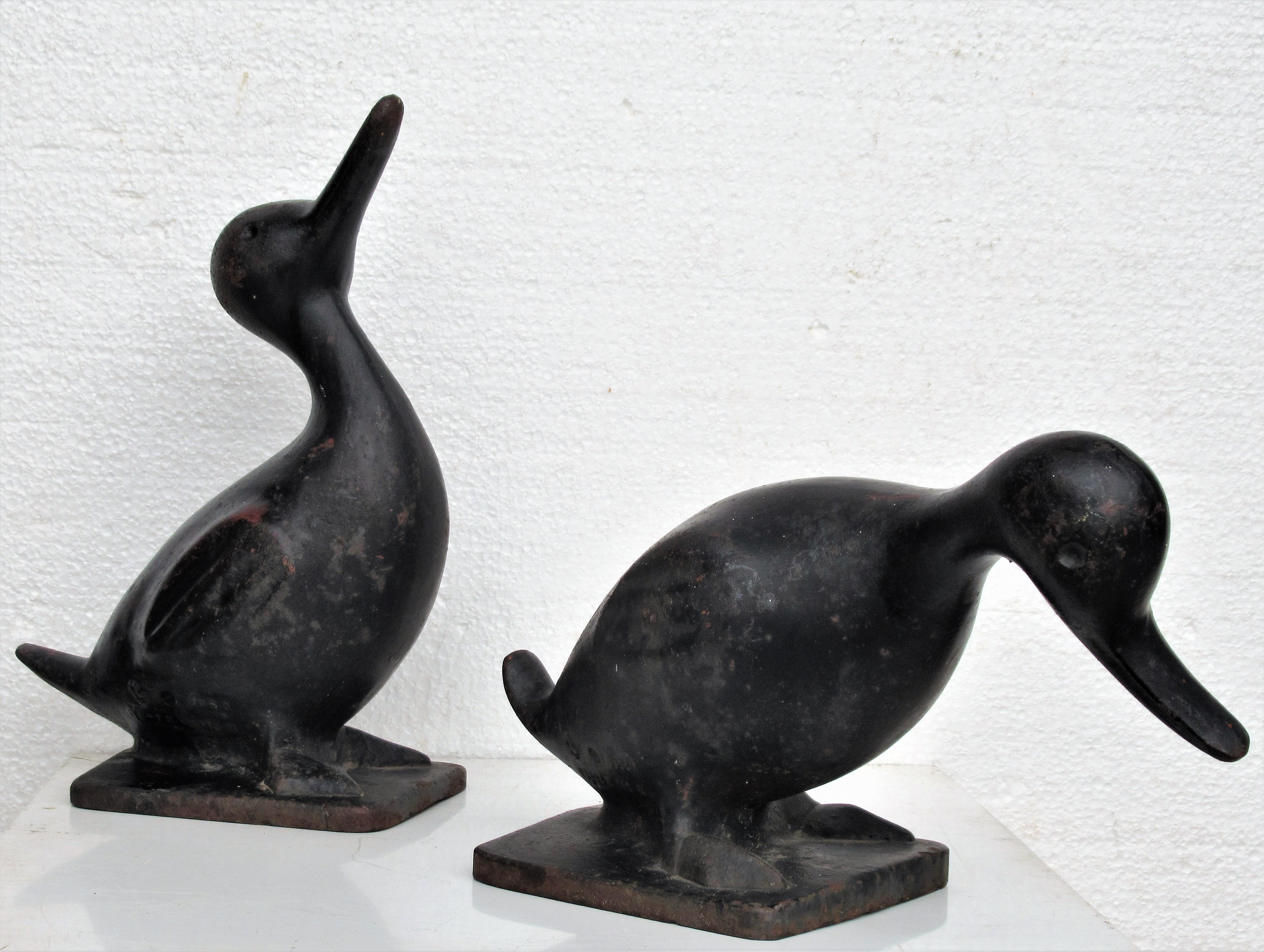 Pair of heavy cast iron ducks in nicely aged original old black painted surface. For garden statues / doorstops. Signed and dated. Very folky American modernist design. Look at all pictures and read condition report in comment section.