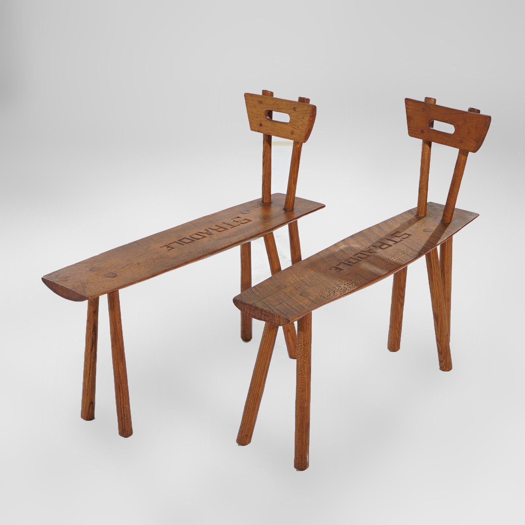 ***Ask About Discounted In-House Shipping***
A pair of Old Hickory Adirondack style straddle benches offers cutout backs over elongated seats and raised on peg legs, 20th century

Measures - 30.25