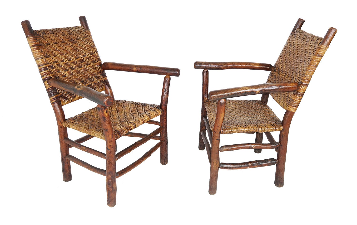 Set of old hickory arm chairs. This pair of old hickory from Martinsville, Indiana arm chairs are in pristine condition and have all original cane seats and backing. The chairs have the original seats and back with great old natural undisturbed