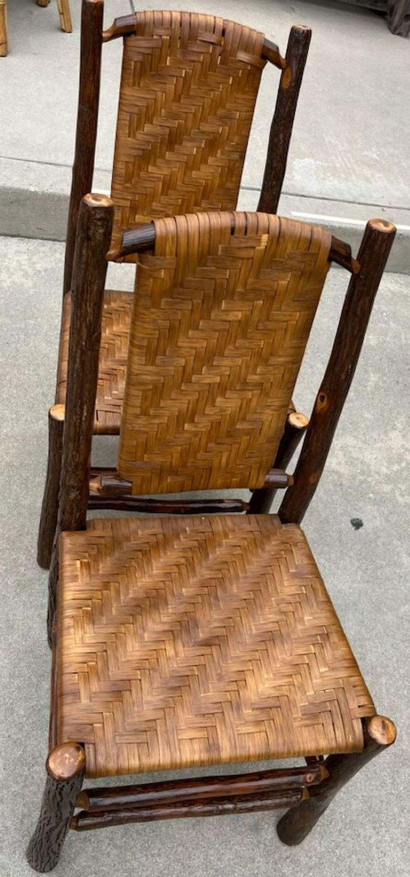 These fine Old Hickory chairs are in fine condition. Wonderful patina and unmatched age and beauty for Adirondack items. The condition are all very good and comfortable.

Original back and hand woven seats.