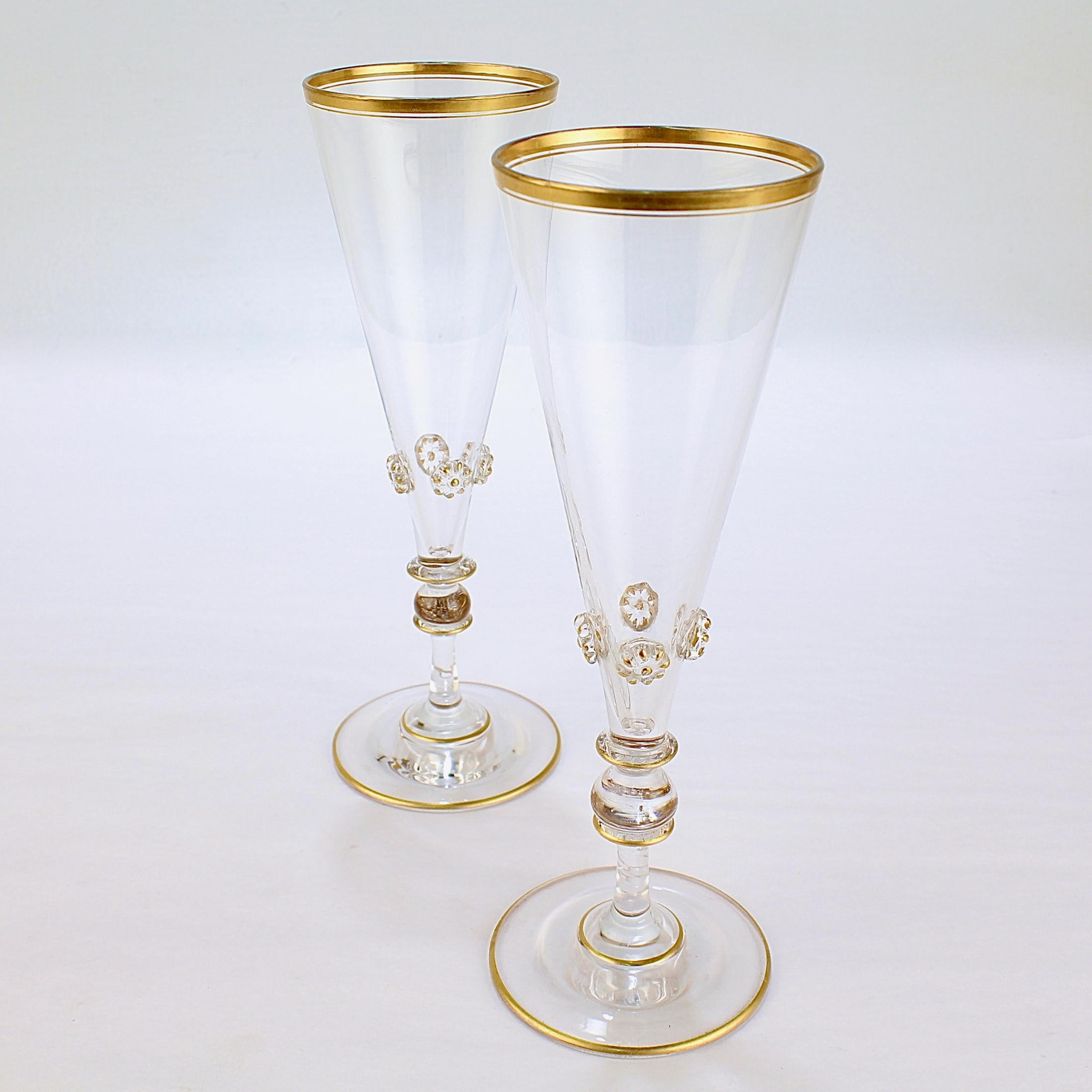 A fine pair of vintage glass champagne flutes.

Likely Bohemian.

With gold trim and highlights throughout and applied knops at the base of each glass cup.

Simply a wonderful pair of toasting stems!

Date:
Early to mid-20th