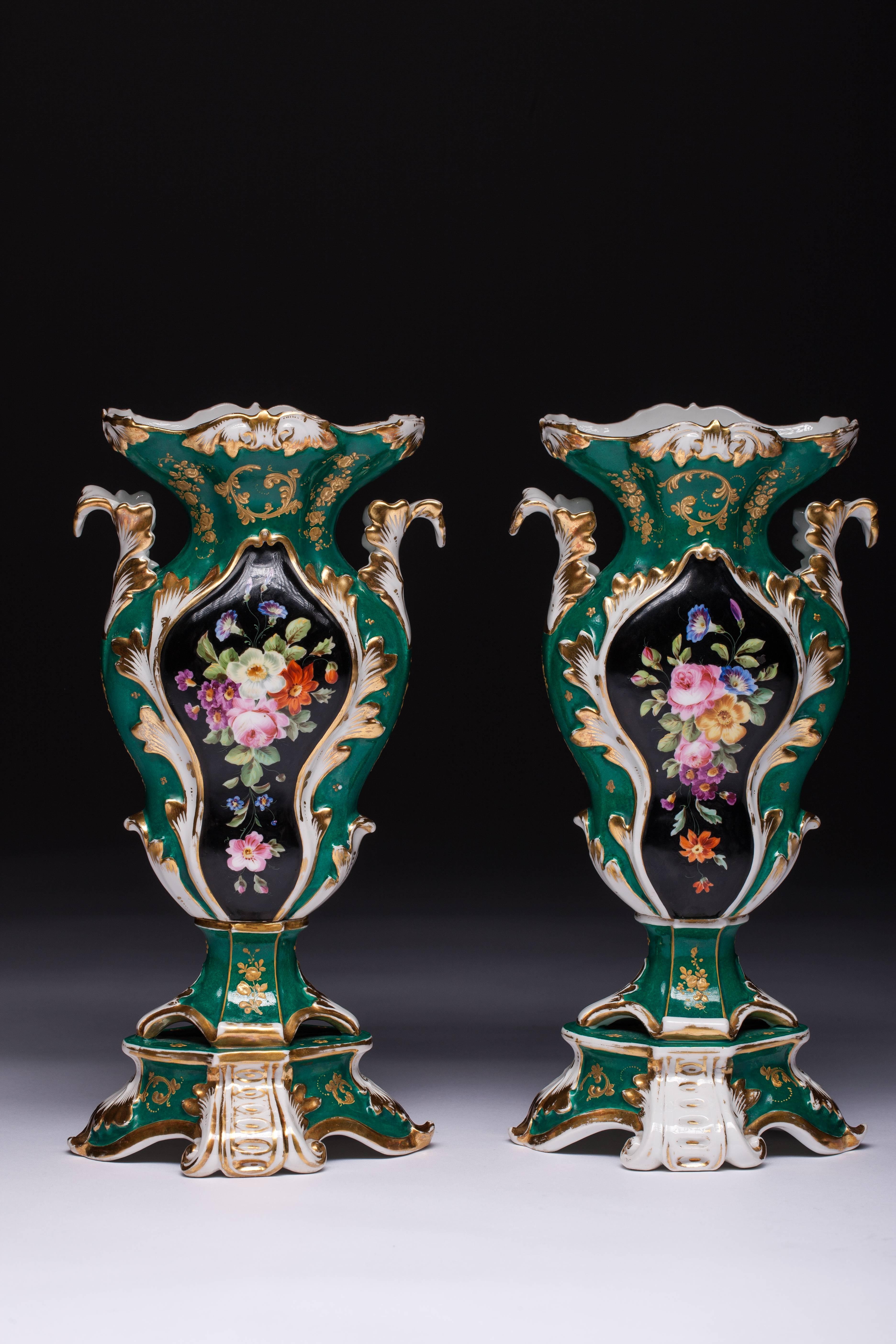 Beautiful pair of Old Paris porcelain vases with a stamp at the bottom F. A. Green Rococo-style vases hand painted with flowers on a black background which is decorated with golden leaves around. Both sides is painted with flowers. Vases are
