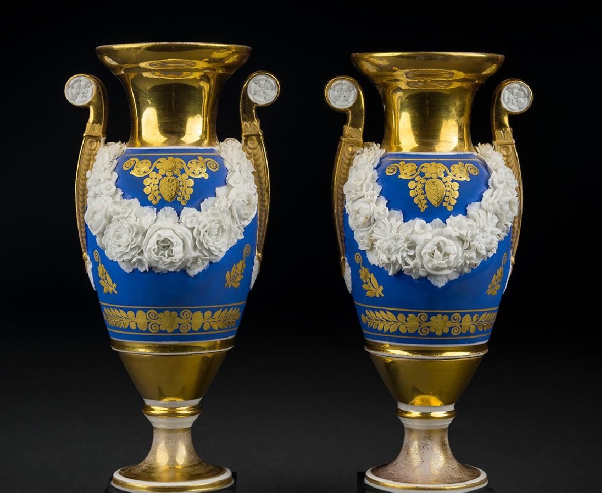 French, circa 1820.

Porcelain, painted and gilded, with applied bisquit flowers

8 13/16 in. high.

Inscribed (with incised mark, under the base of each): 3.
  