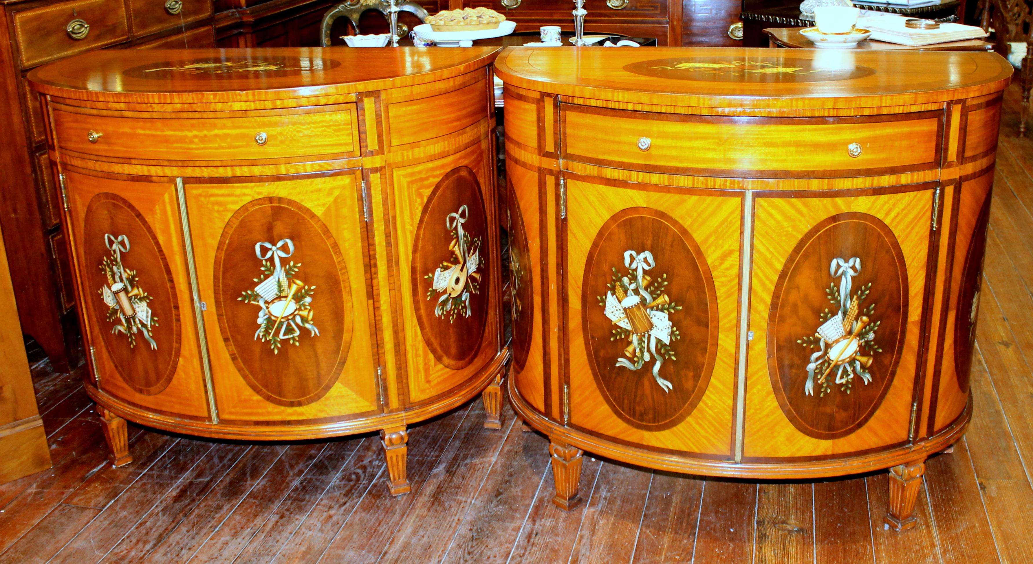 Pair of fabulous quality old reprod. George III style hand painted inlaid satinwood demilune commodes (European-made, possibly Italian).

Please note hand painted oval panels of musical instruments and figured satinwood overall. These are a