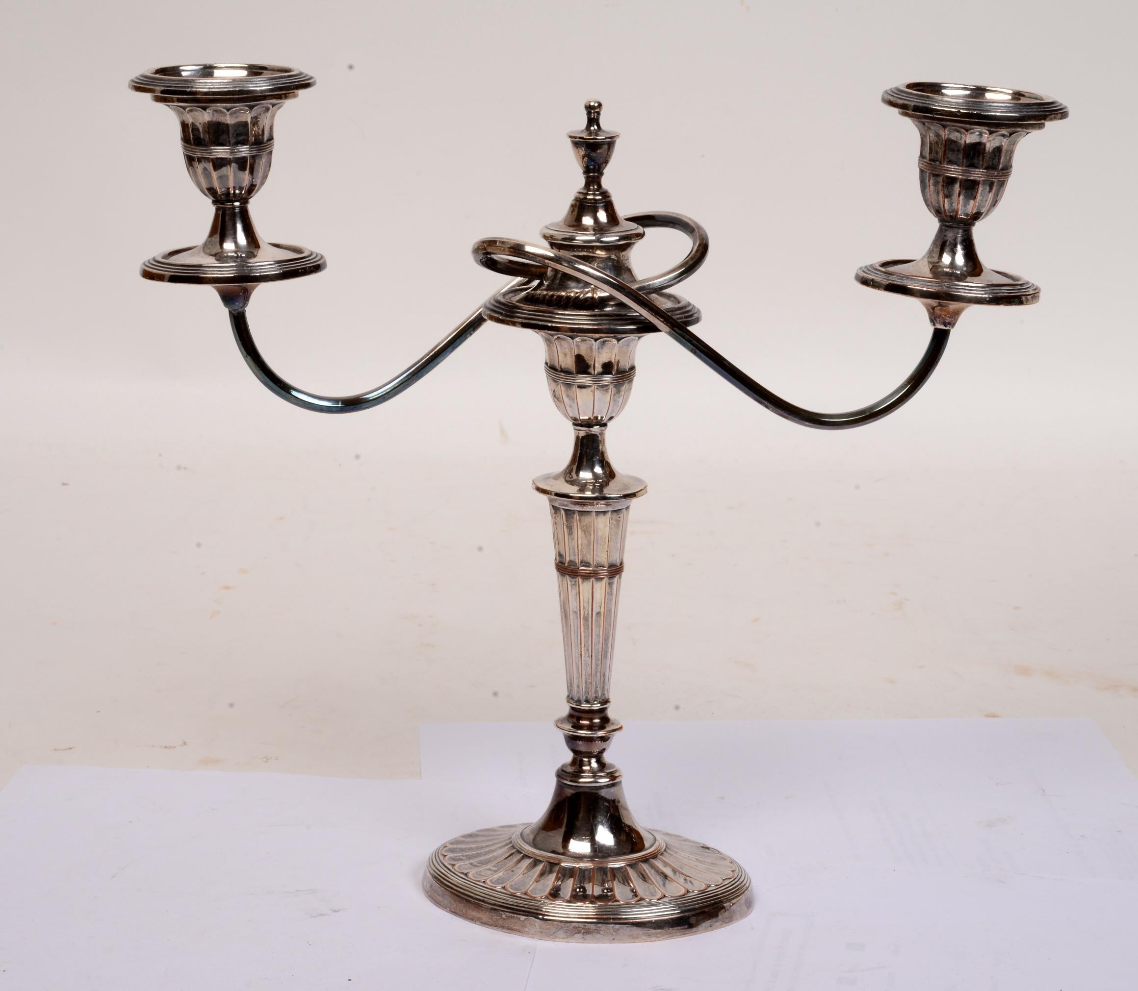Pair of old Sheffield plate Geo III neoclassical two-light candelabra, circa 1800. The branch arms are removable to convert the candelabra into a pair of candlesticks. The oval bases have 